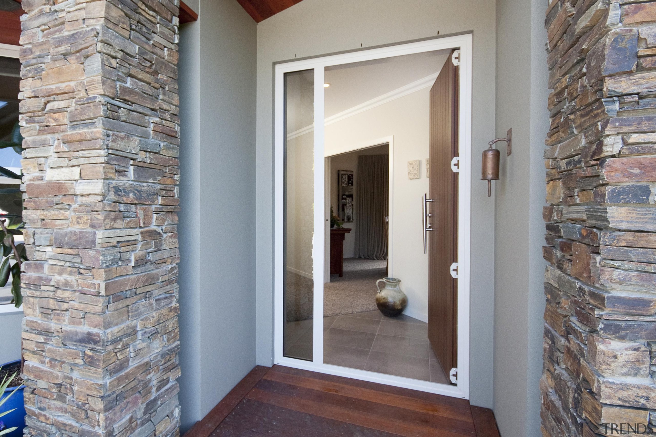 Schist pillars define the entrance to this Taranaki brick, door, estate, floor, flooring, home, property, real estate, wall, window, gray
