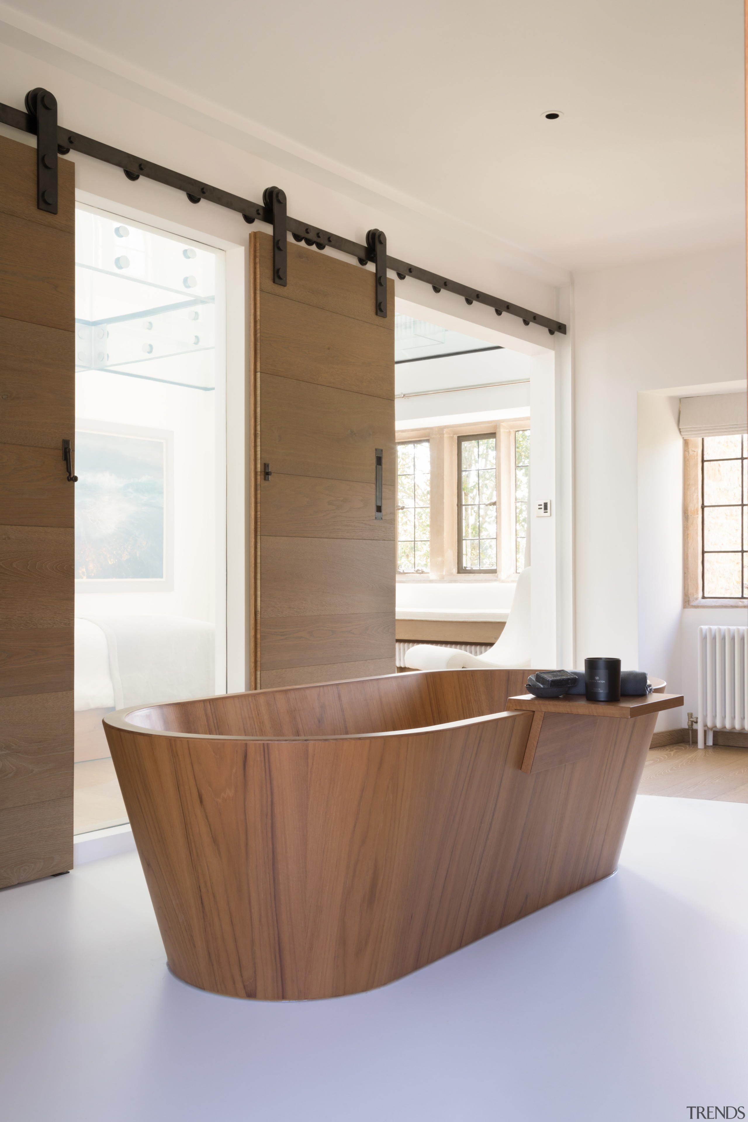 The bespoke sculptural teak bath has a remote-operated 