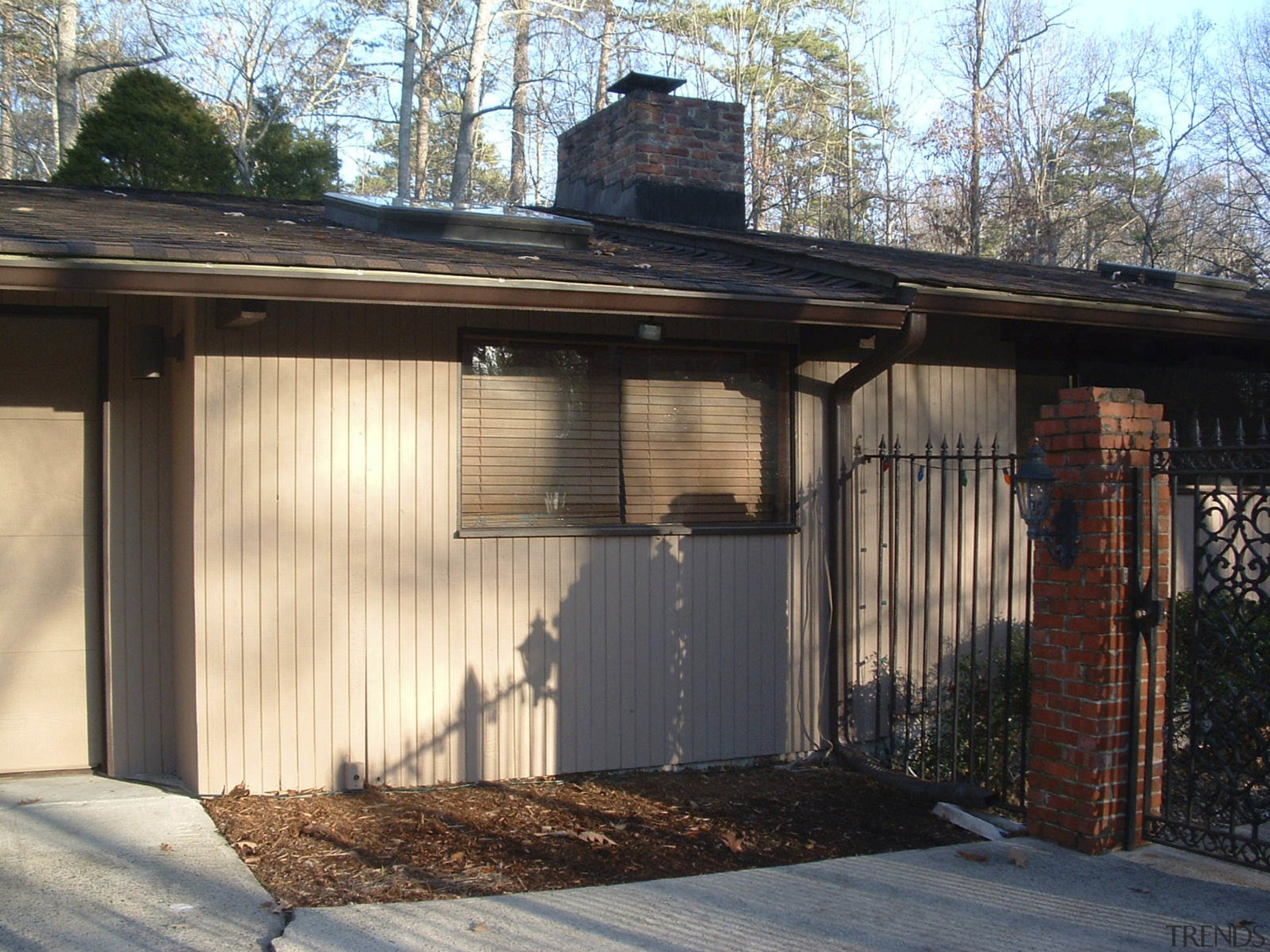 This is a picture of a prefabricated post-and-beam facade, home, house, outdoor structure, property, real estate, roof, shed, siding, black