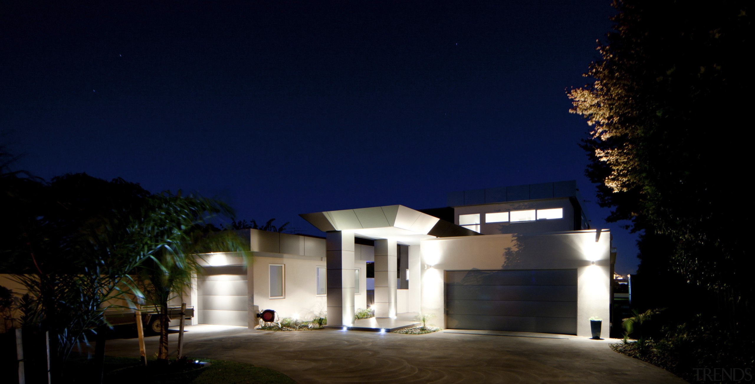 This house was designed and built by Signature architecture, building, darkness, estate, facade, home, house, landscape lighting, light, lighting, night, property, real estate, residential area, sky, blue, black