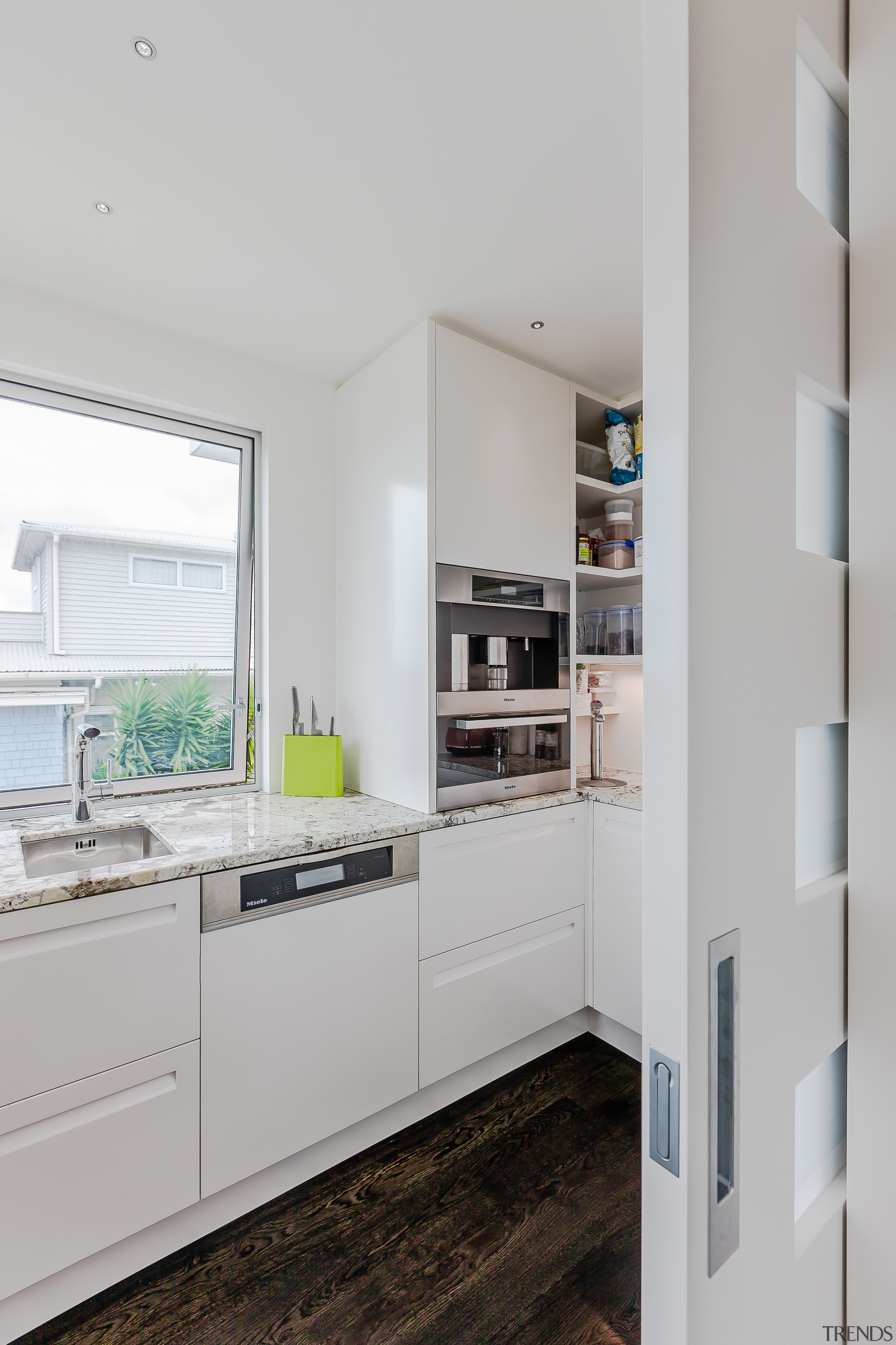 Hidden behind a sliding door, the scullery in cabinetry, countertop, cuisine classique, home appliance, interior design, kitchen, refrigerator, gray