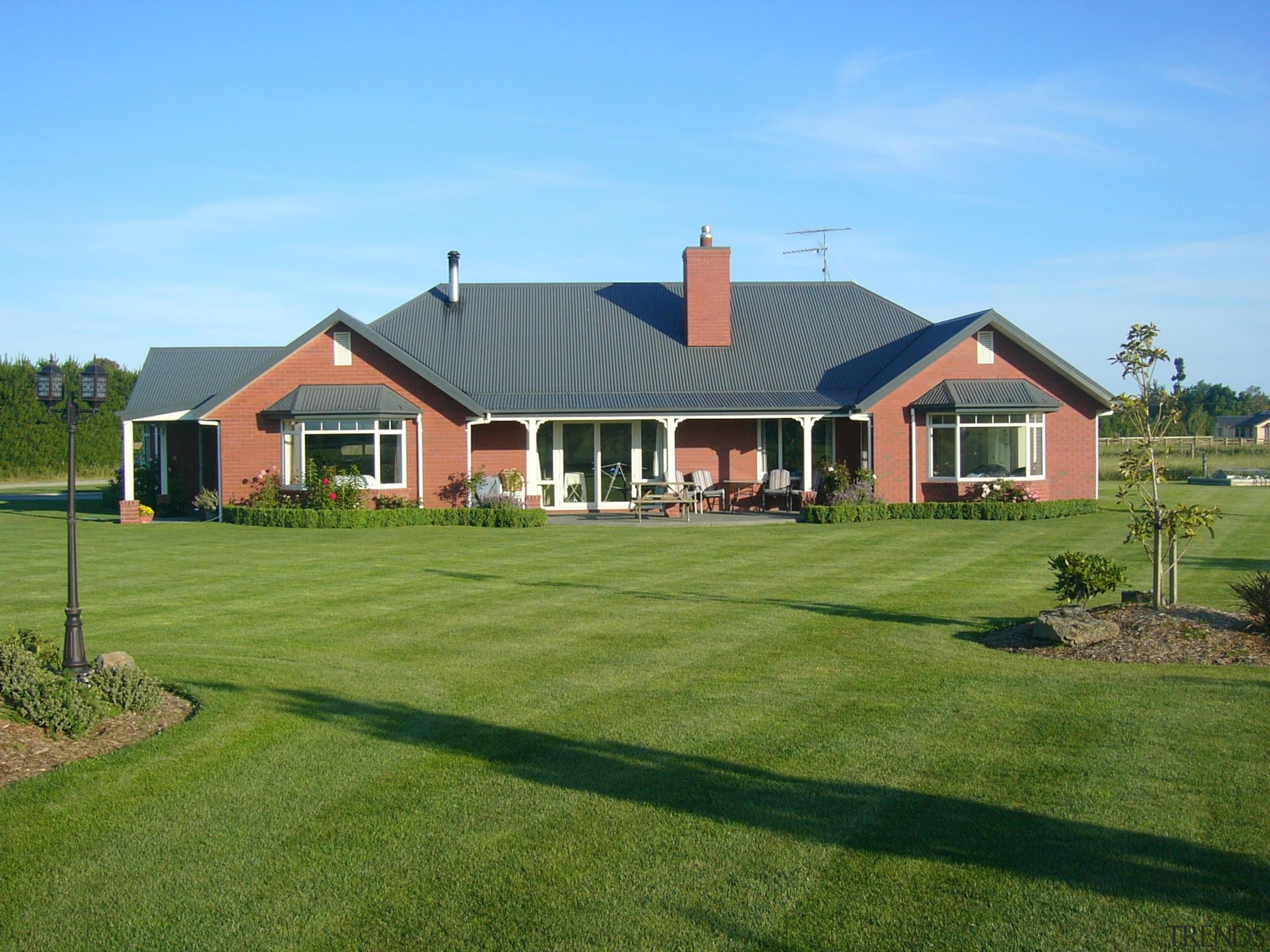 A Canterbury kiln fired red brick home of backyard, cottage, elevation, estate, facade, farm, farmhouse, golf club, grass, home, house, land lot, landscape, landscaping, lawn, plantation, property, real estate, residential area, roof, siding, suburb, yard, green, teal