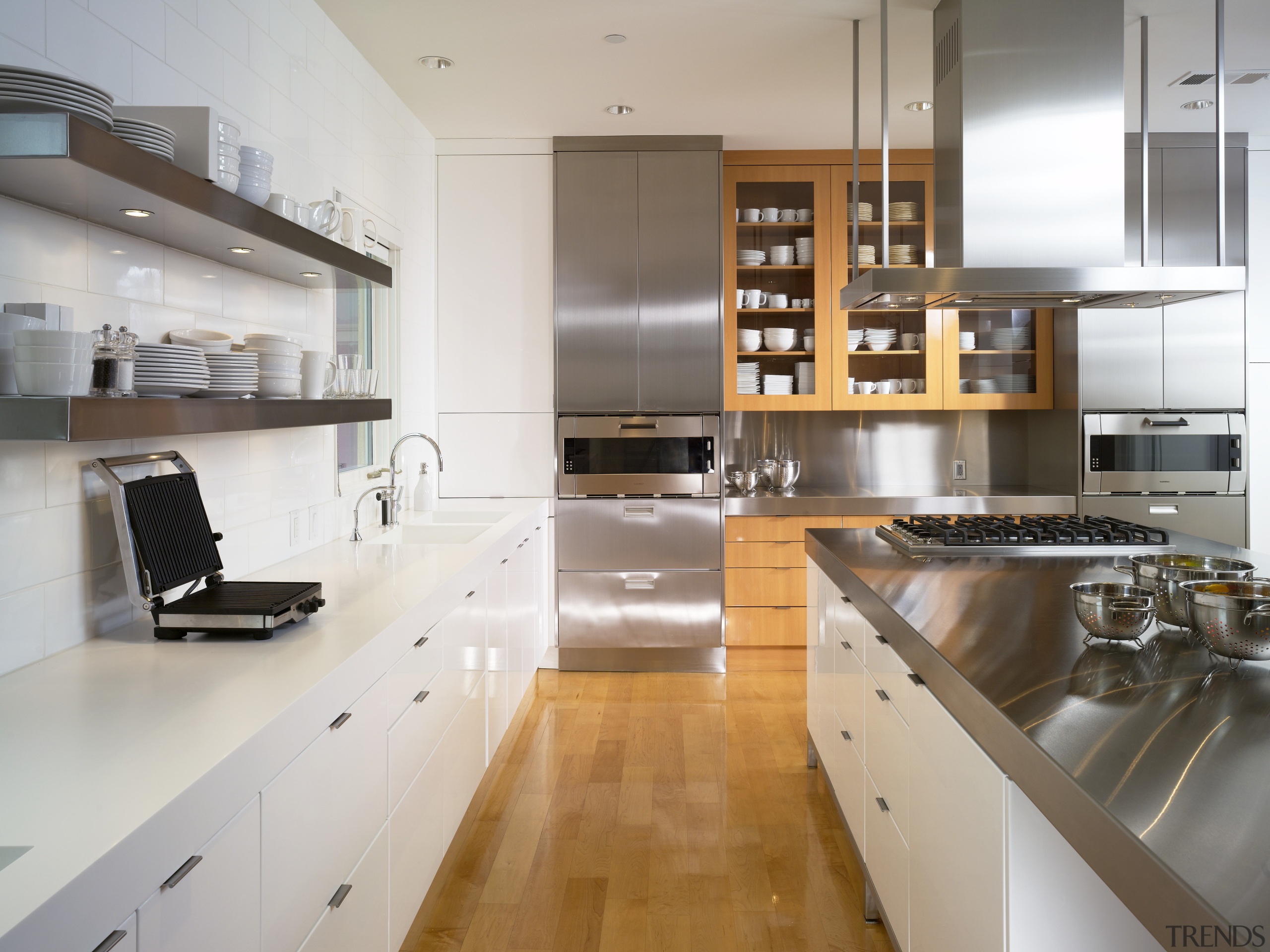 View of a condominium kitchen which features a cabinetry, countertop, cuisine classique, interior design, kitchen, gray