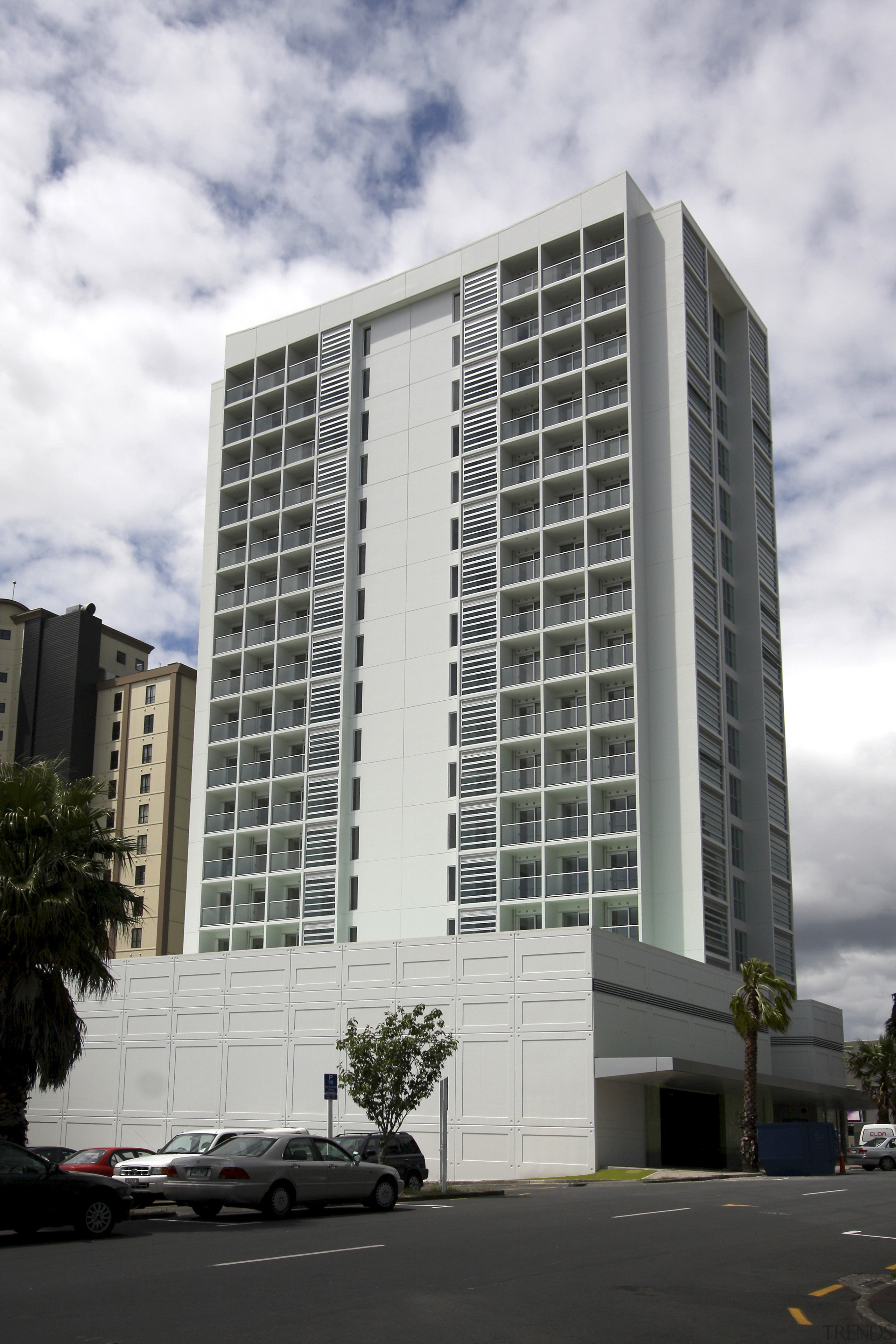 Exterior view of the entrance way of the apartment, architecture, building, commercial building, condominium, corporate headquarters, daytime, facade, headquarters, metropolis, metropolitan area, mixed use, residential area, sky, skyscraper, tower block, white, black