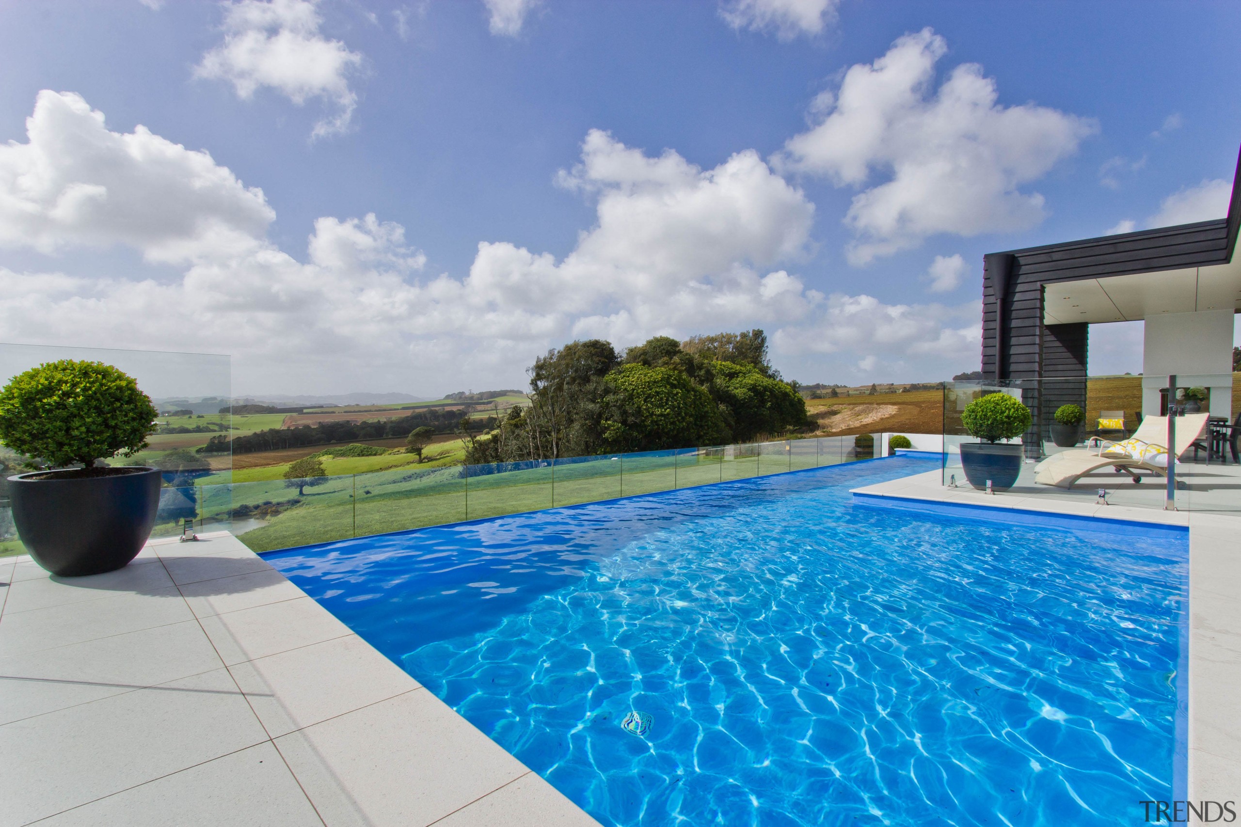 Infinity pool for country house by Mayfair Pools. estate, home, house, leisure, property, real estate, resort, sky, swimming pool, villa, water, gray