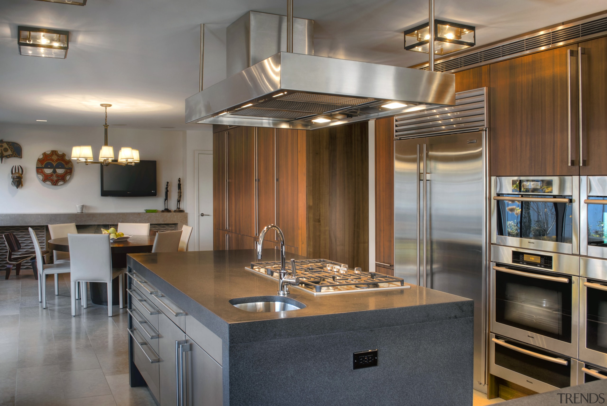 View of contemporary kitchen and dining area with cabinetry, countertop, cuisine classique, interior design, kitchen, real estate, room, gray, brown