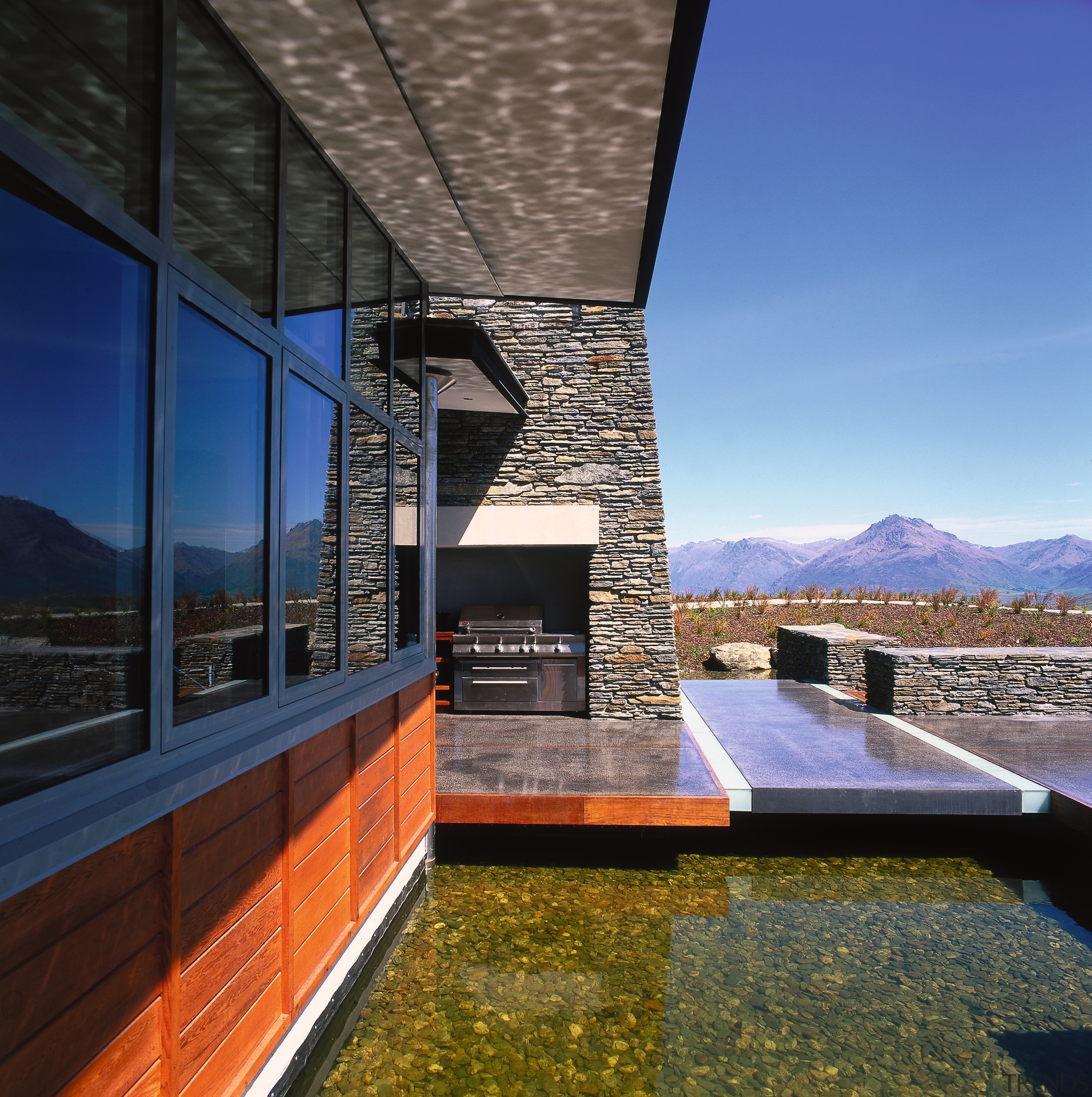 view of theis new house tucked beneath the architecture, building, home, house, real estate, reflection, roof, sky, black, blue