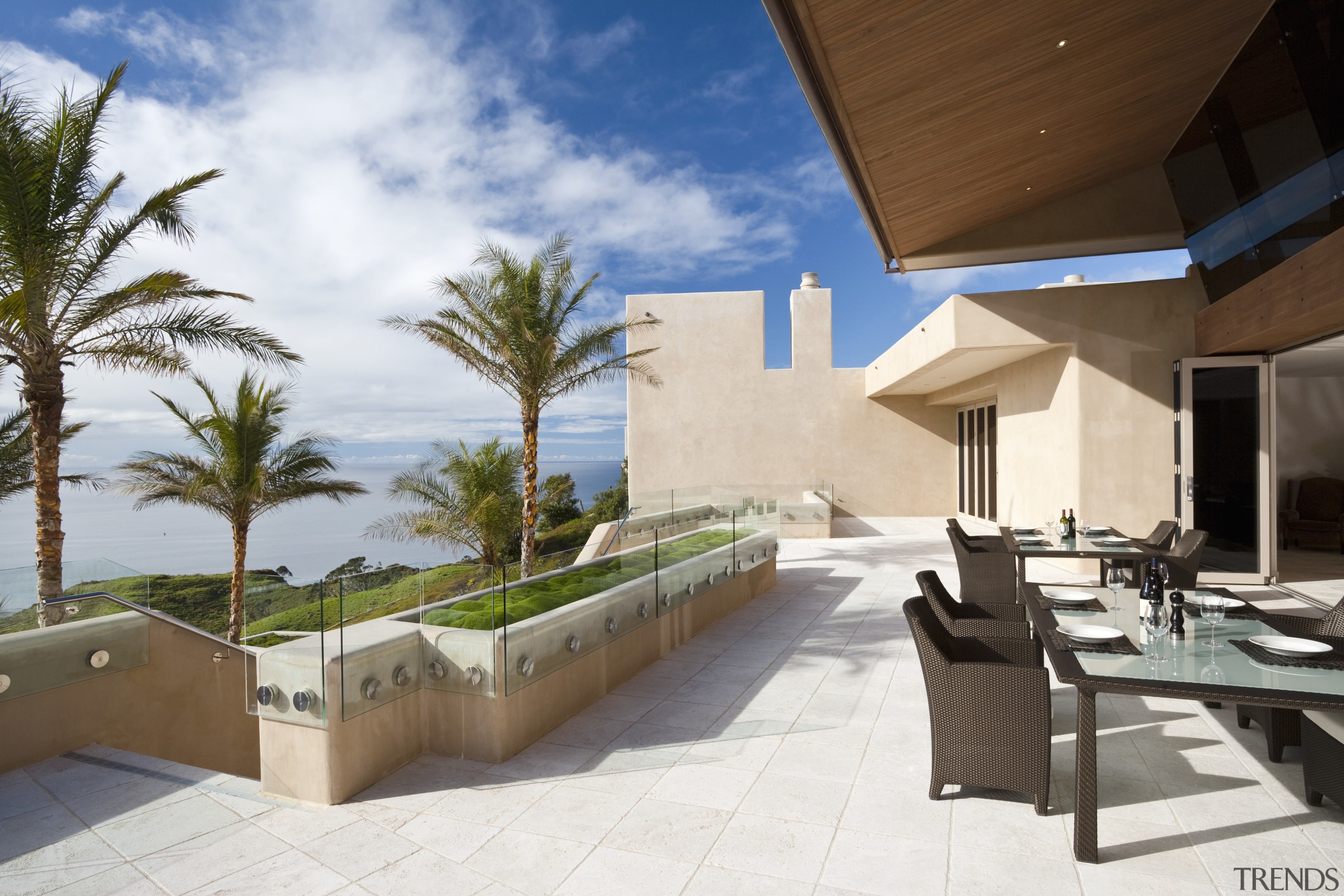 View of patio area with outdoor dining furniture, apartment, architecture, condominium, estate, home, house, property, real estate, resort, swimming pool, villa, white, brown