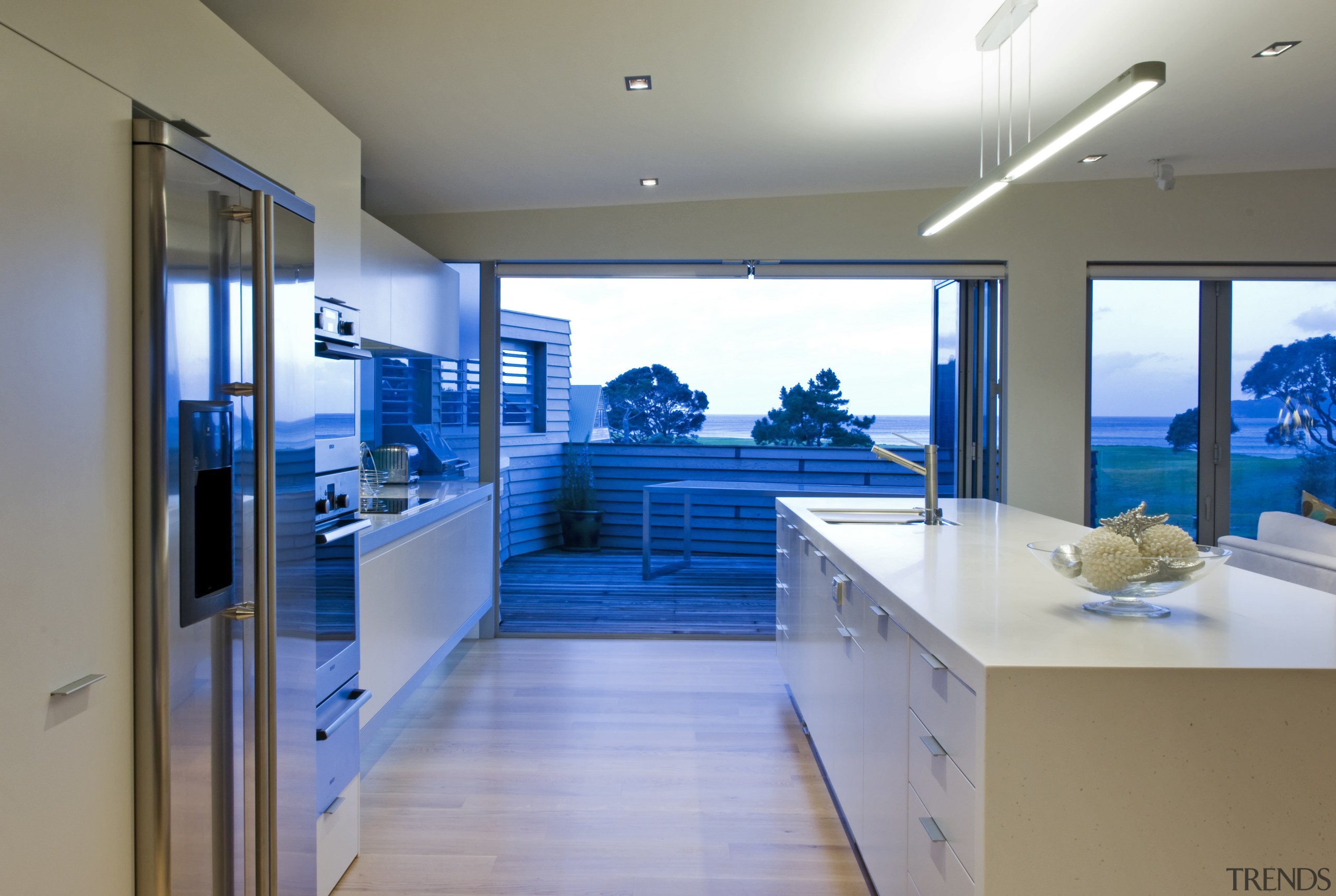 This sleek kitchen in a beach house features interior design, gray