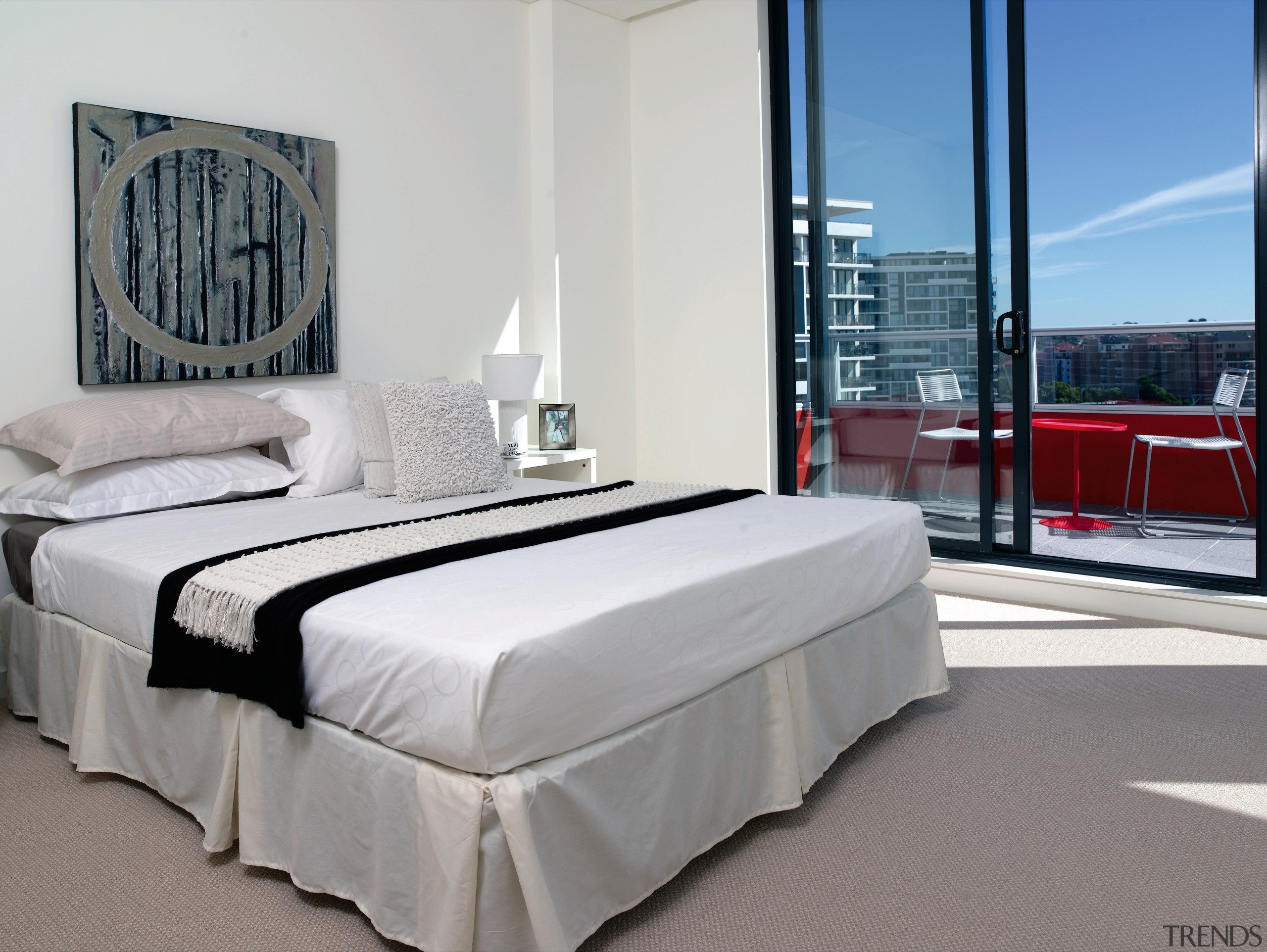 A view of the master bedroom featuring carpet bed, bed frame, bed sheet, bedroom, floor, flooring, furniture, home, interior design, mattress, property, real estate, room, suite, wall, gray