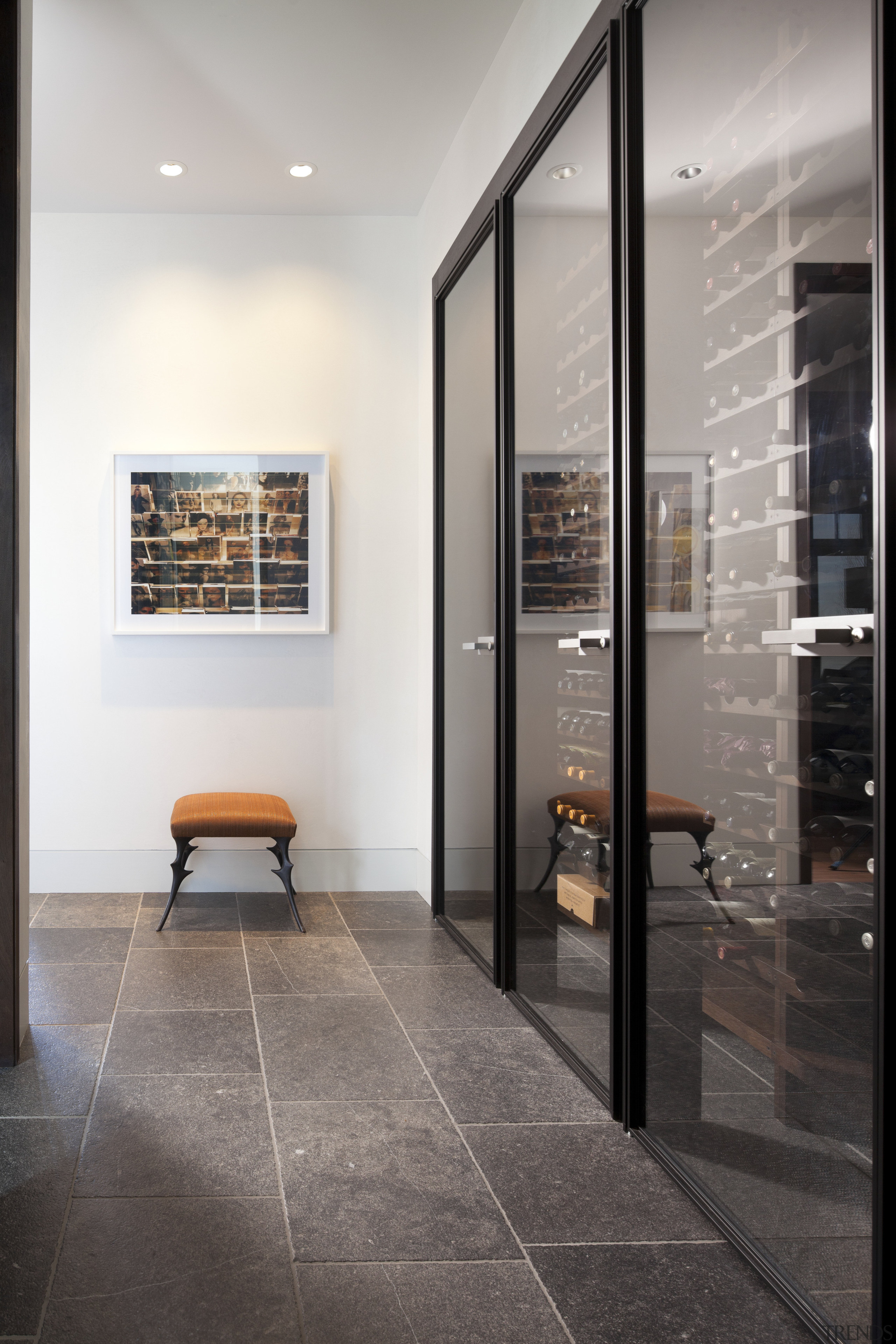 A climate-controlled wine cellar is close to the door, floor, flooring, glass, interior design, lobby, tile, gray