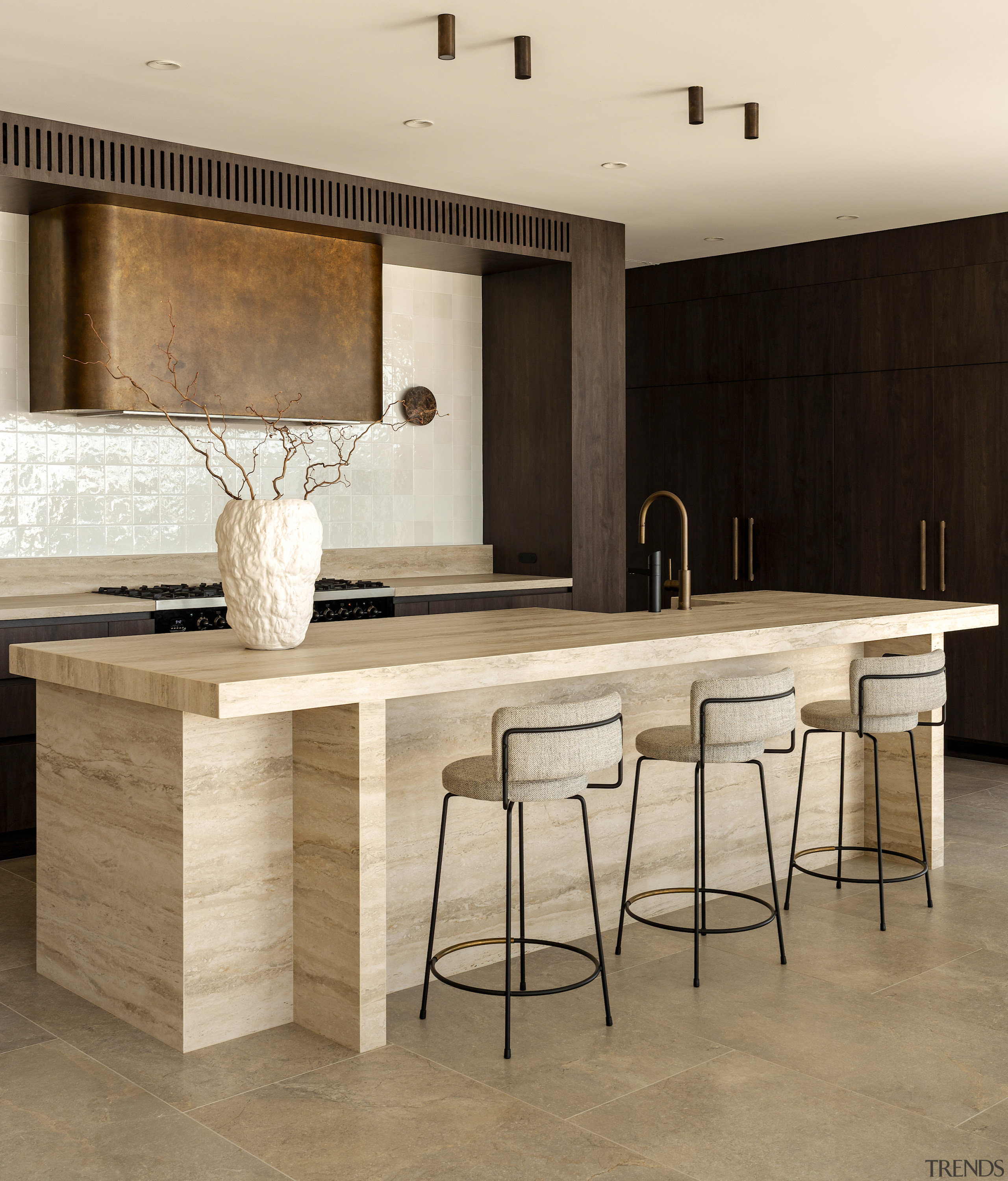 The expansive stone-clad island incorporates a breakfast bar. 