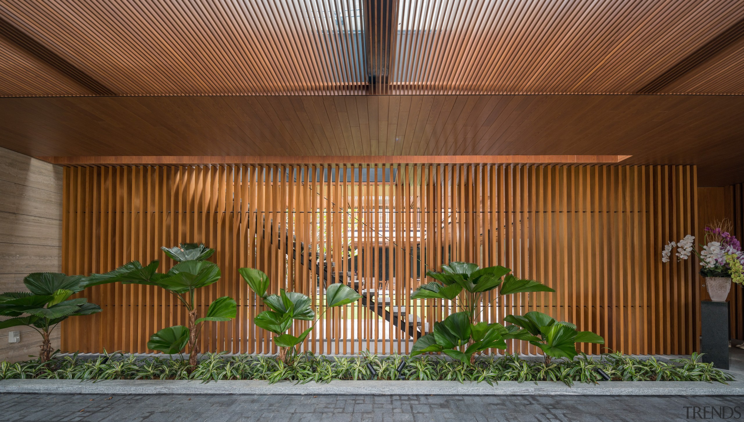 The porte-cochère's slatted wall offers glimpses into the 