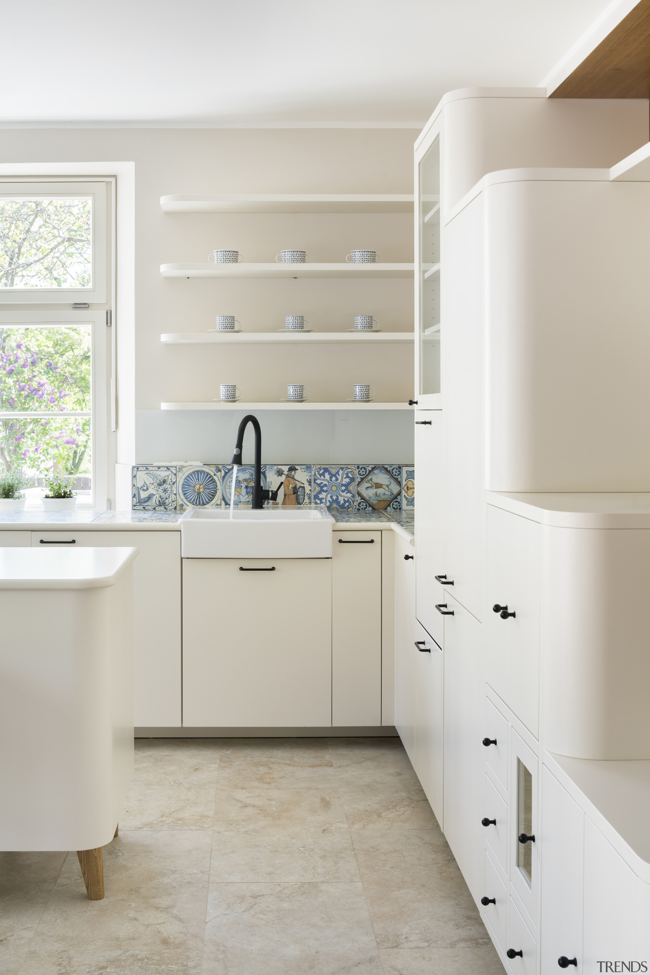 Cream, rounded kitchen cabinetry on the first floor 