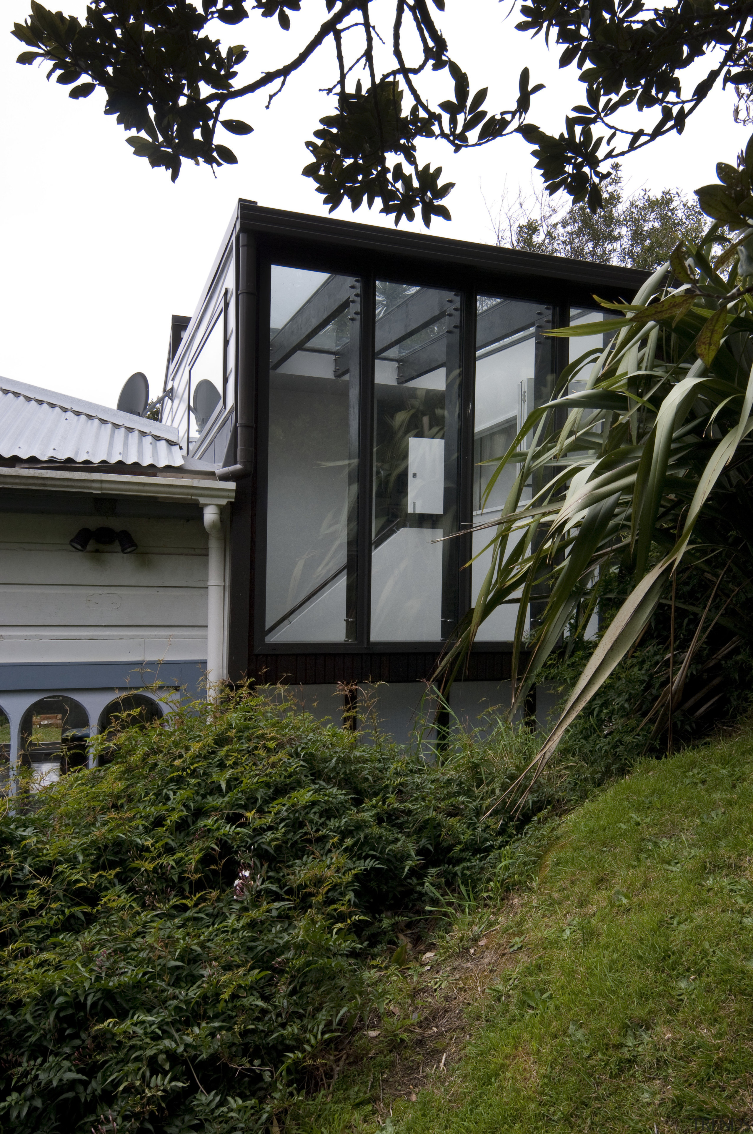 Exterior view of addon - Exterior view of architecture, building, cottage, facade, grass, home, house, outdoor structure, plant, real estate, residential area, tree, window, black, brown