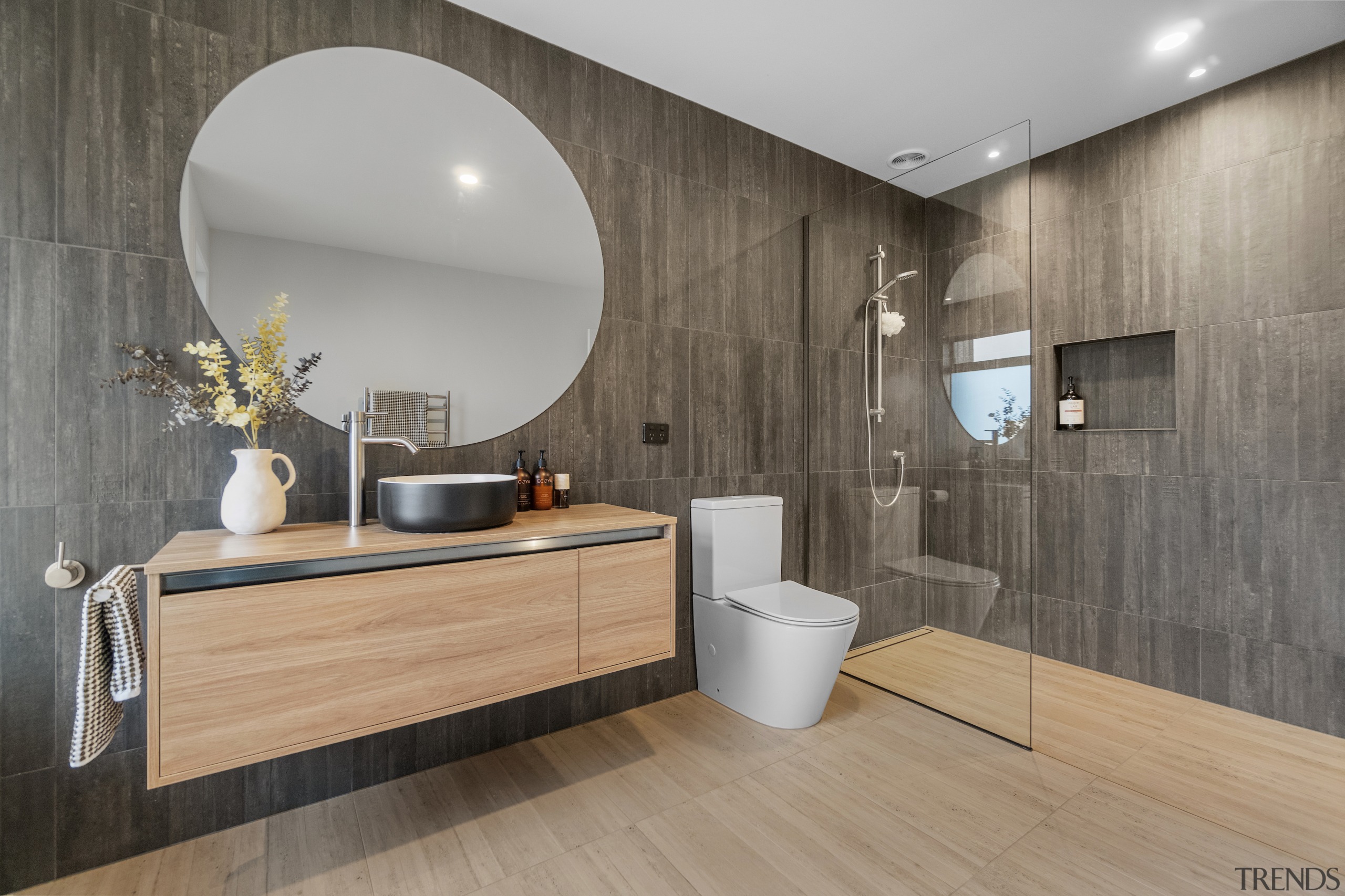 A wood-look wall tile in the bathroom seems 