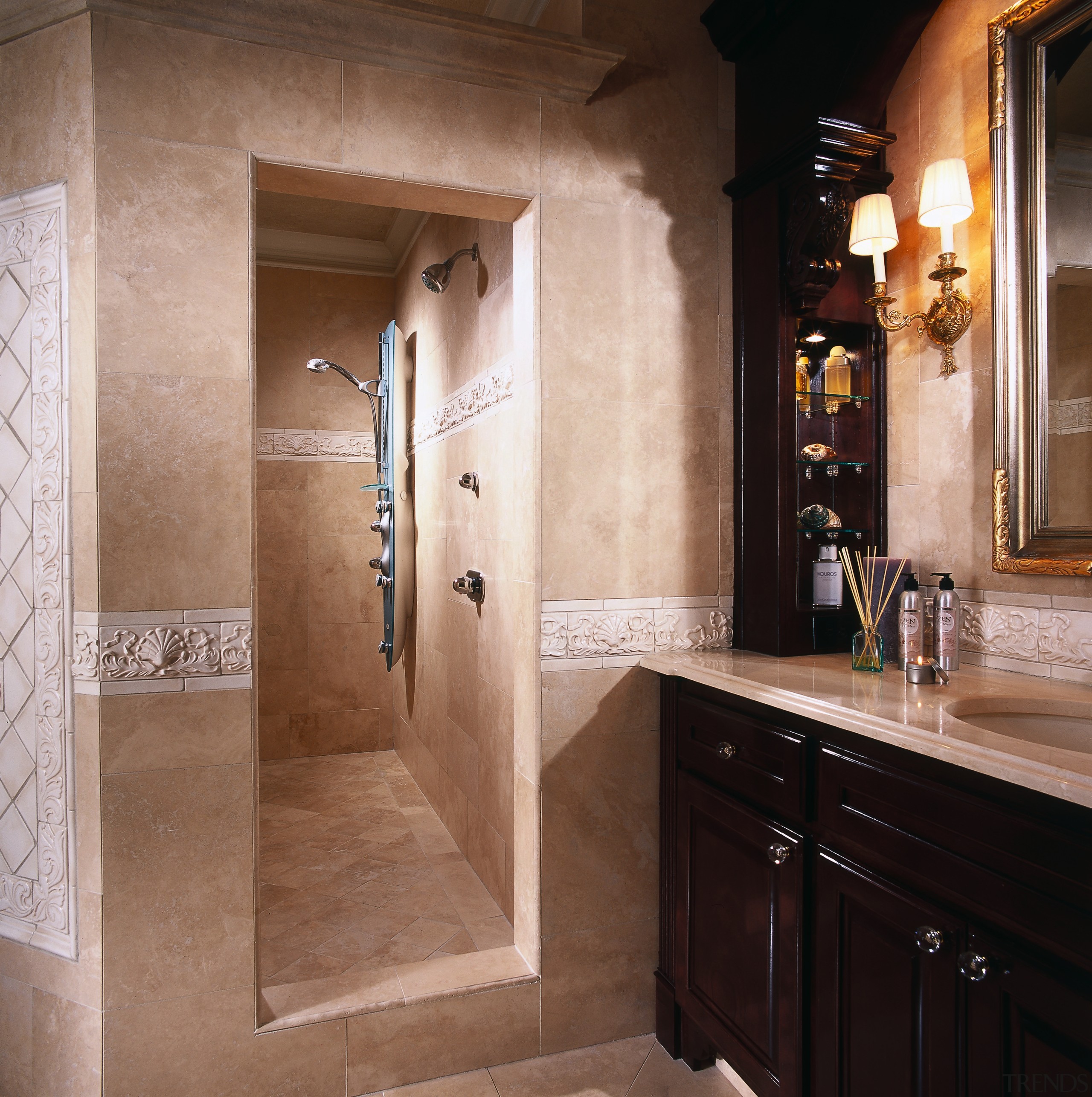 the shower enclosure is located behind limestone walls bathroom, cabinetry, countertop, flooring, interior design, room, brown, black