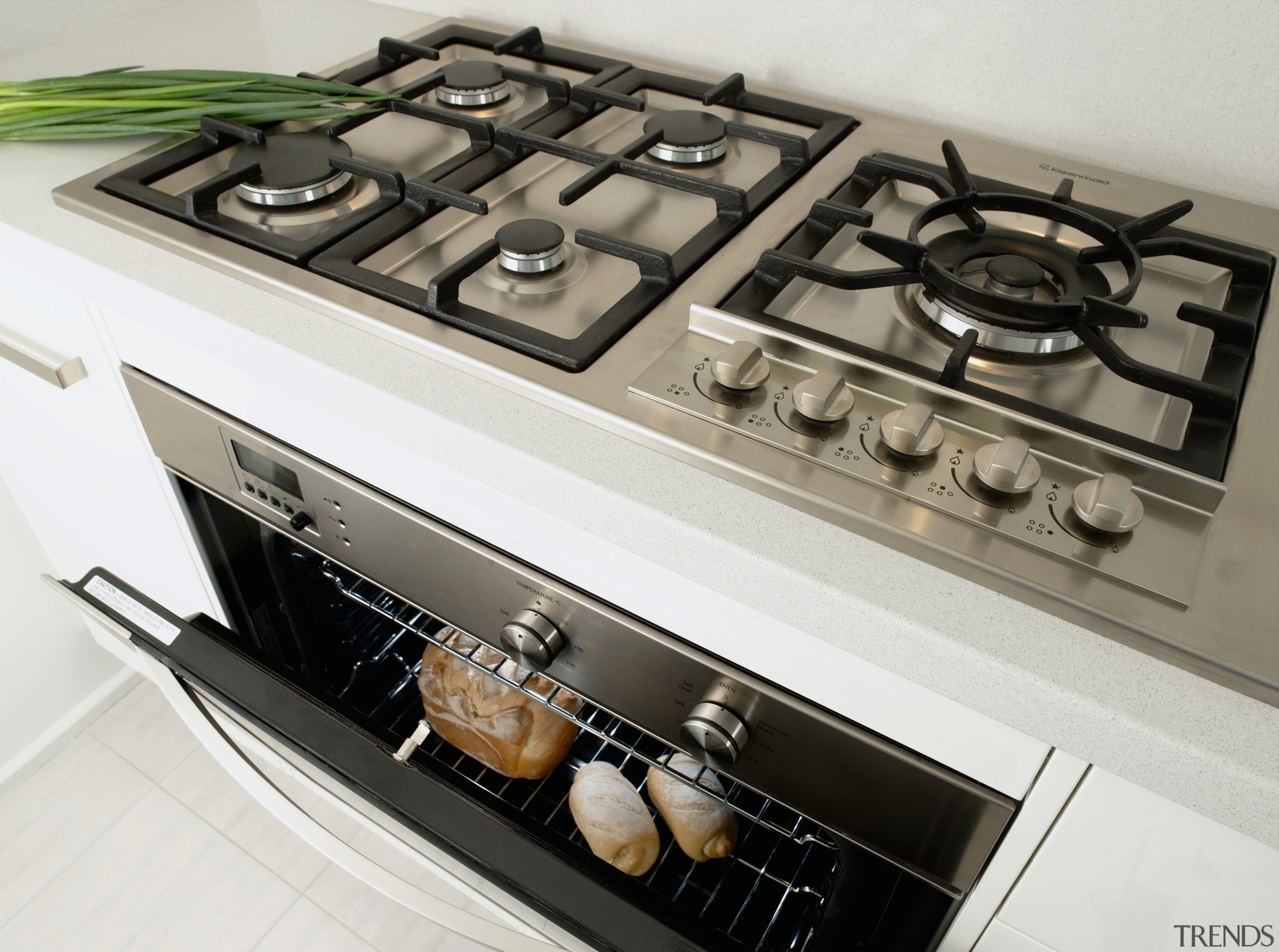 A view of a kitchen area, white cabinetry cooktop, gas stove, home appliance, kitchen, kitchen appliance, kitchen stove, major appliance, white, gray