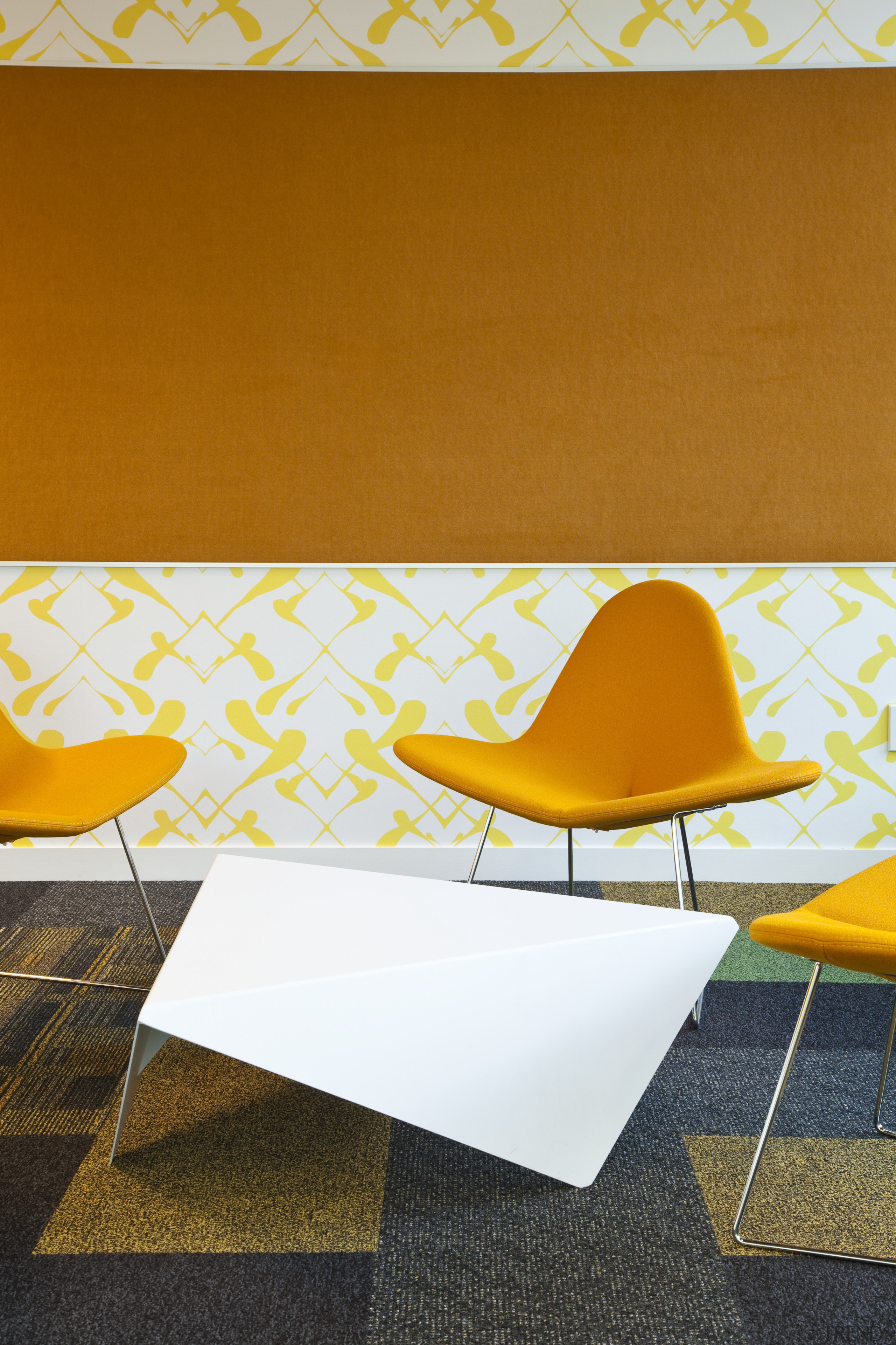 View of furnishings by Fletcher Systems for the angle, chair, design, floor, flooring, furniture, interior design, line, orange, product design, table, wall, wood, yellow, white, orange, brown
