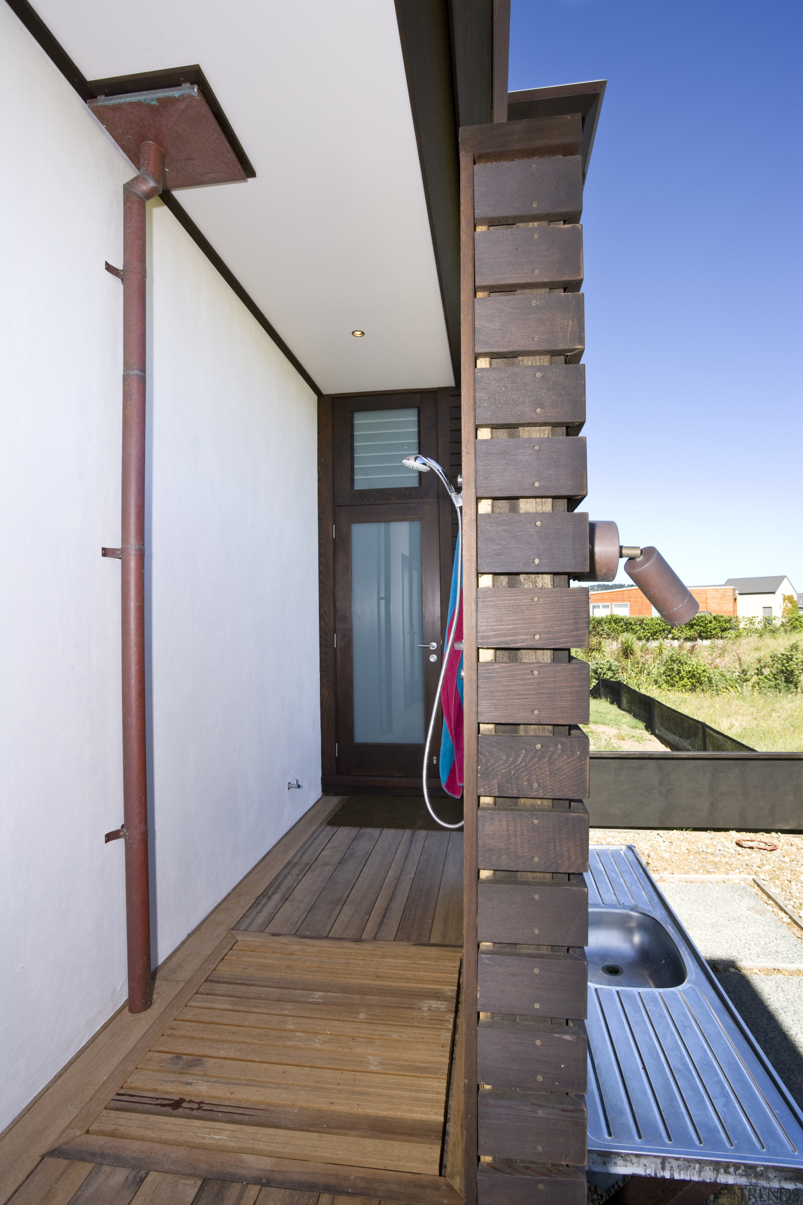 View of an outdoor shower, decking, shower fittings. architecture, daylighting, handrail, house, stairs, structure, wood, white