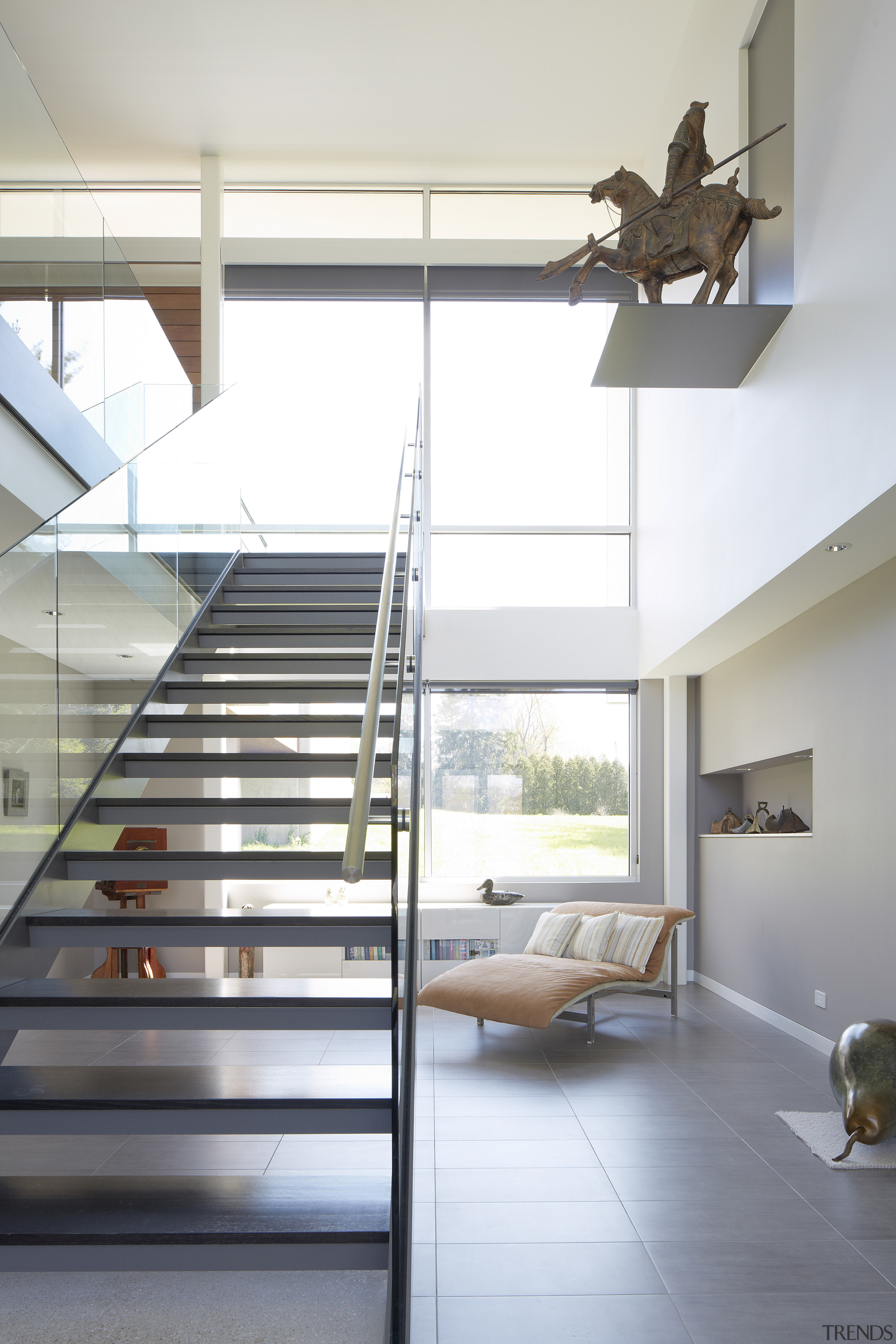 A double-height void adds drama and transparency to architecture, daylighting, floor, handrail, home, house, interior design, loft, product design, stairs, white, gray