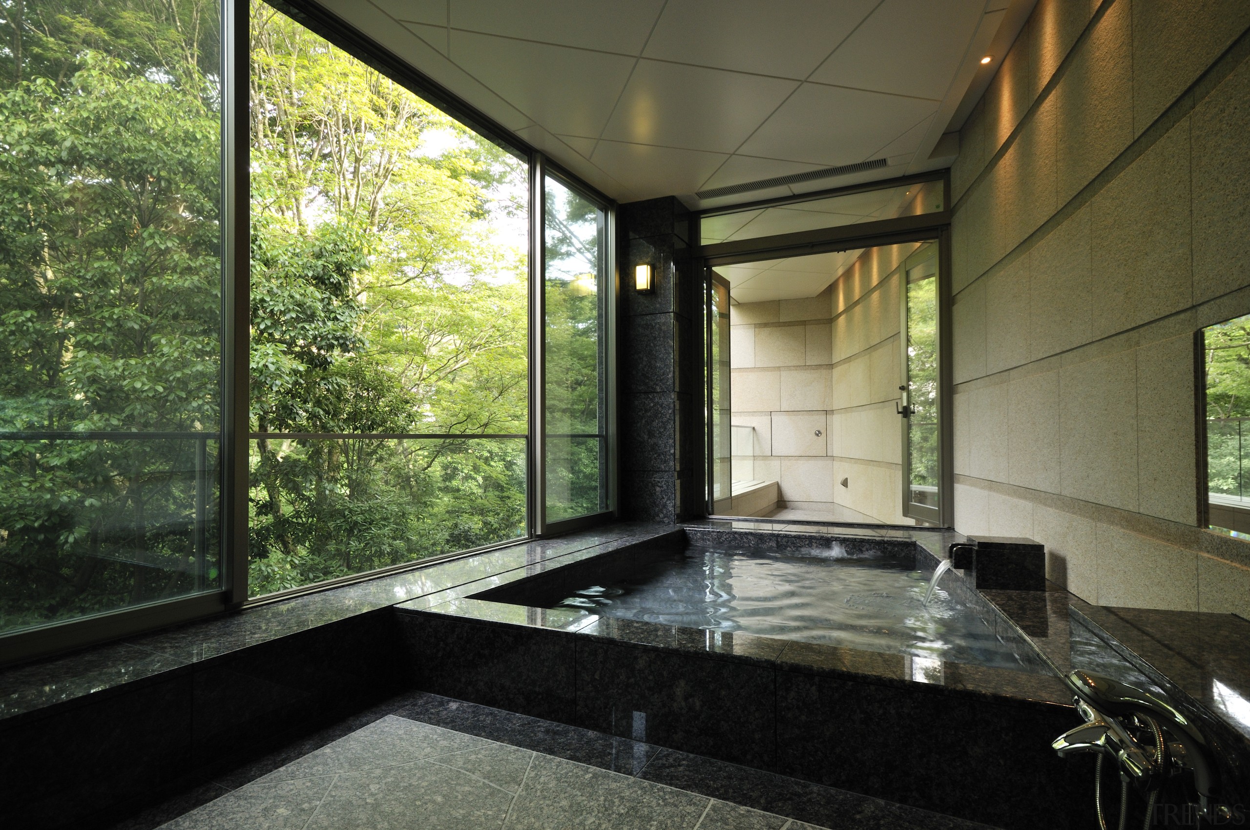 View of the bathroom which features extensive granite architecture, bathtub, estate, home, house, interior design, property, real estate, window, brown