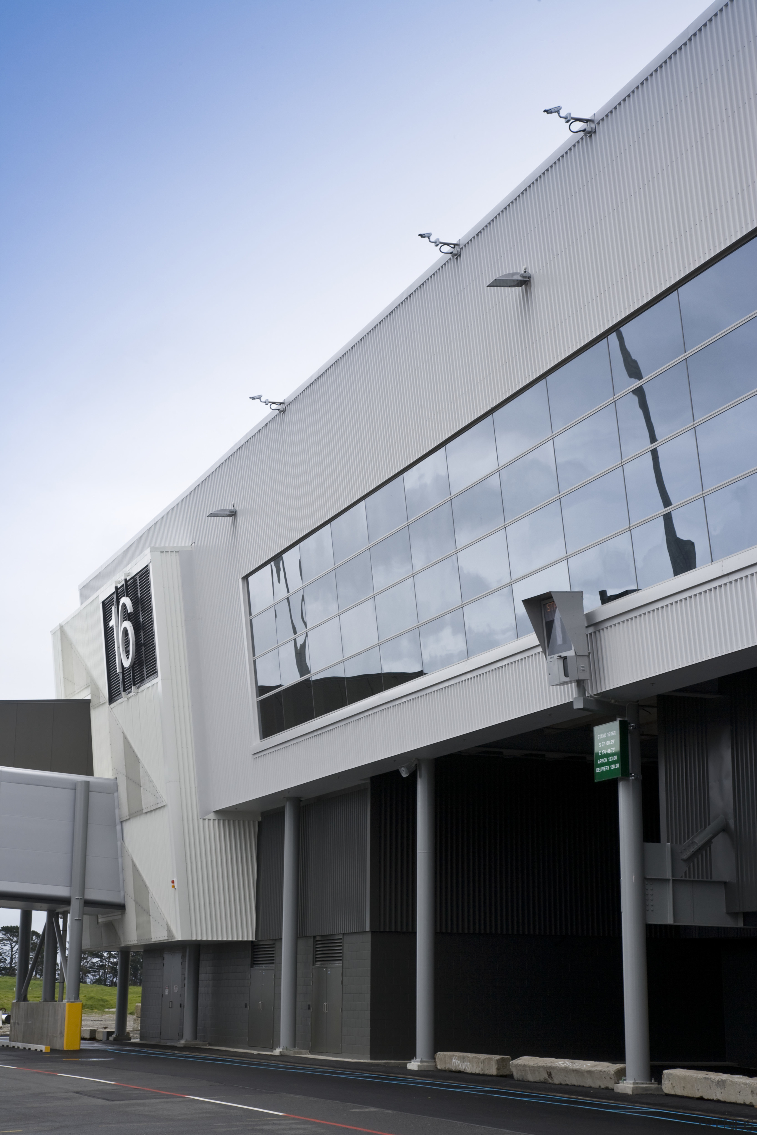 View of Auckland Airport's new international terminal where architecture, building, commercial building, corporate headquarters, daylighting, daytime, facade, house, real estate, residential area, roof, sky, structure, window, gray, black