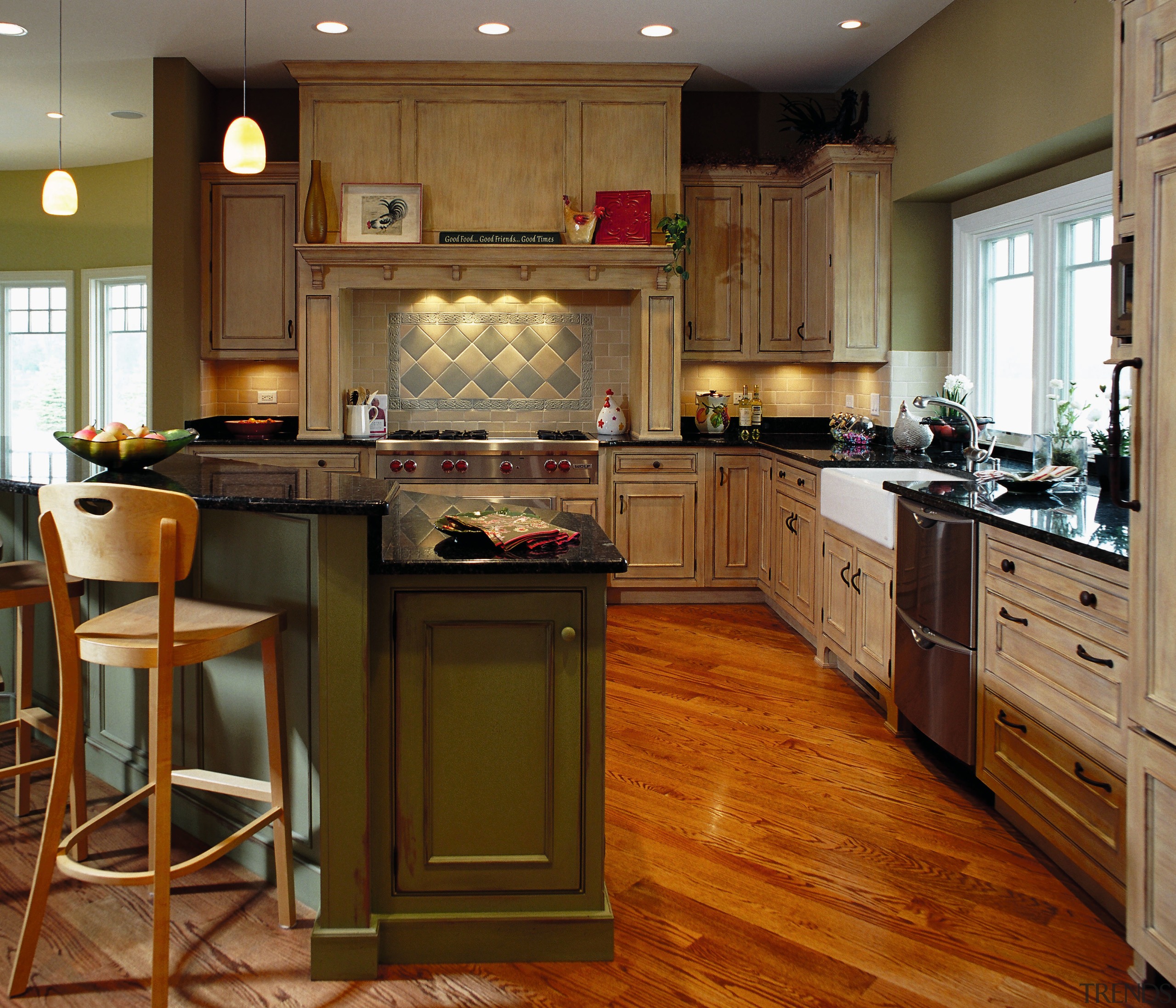 View of this traditional kitchen featuring grean teak cabinetry, countertop, cuisine classique, floor, flooring, hardwood, interior design, kitchen, laminate flooring, room, wood flooring, brown