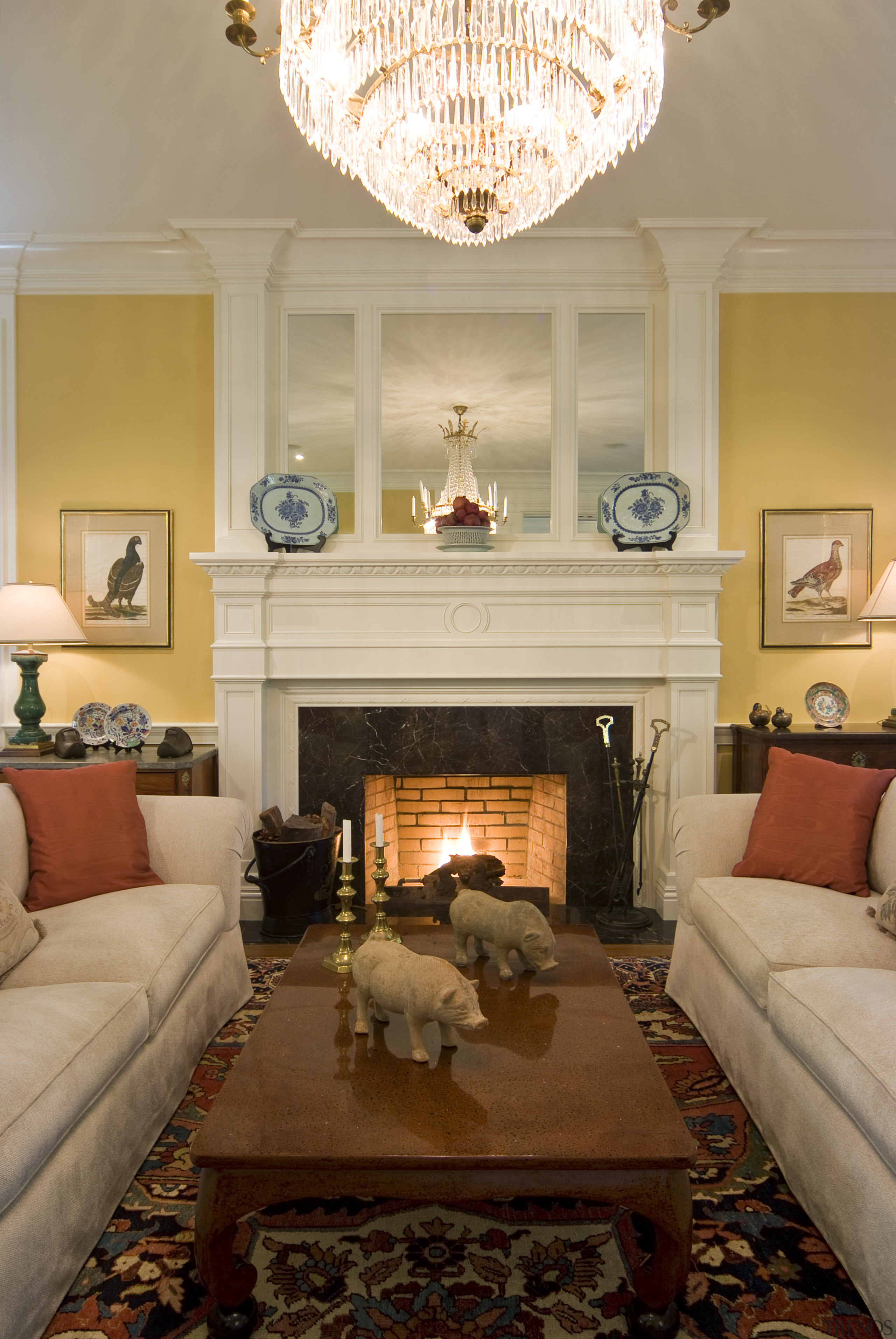 View of lounge area with fireplace, yellow walls ceiling, couch, fireplace, furniture, hearth, home, interior design, living room, room, table, wall, orange, brown