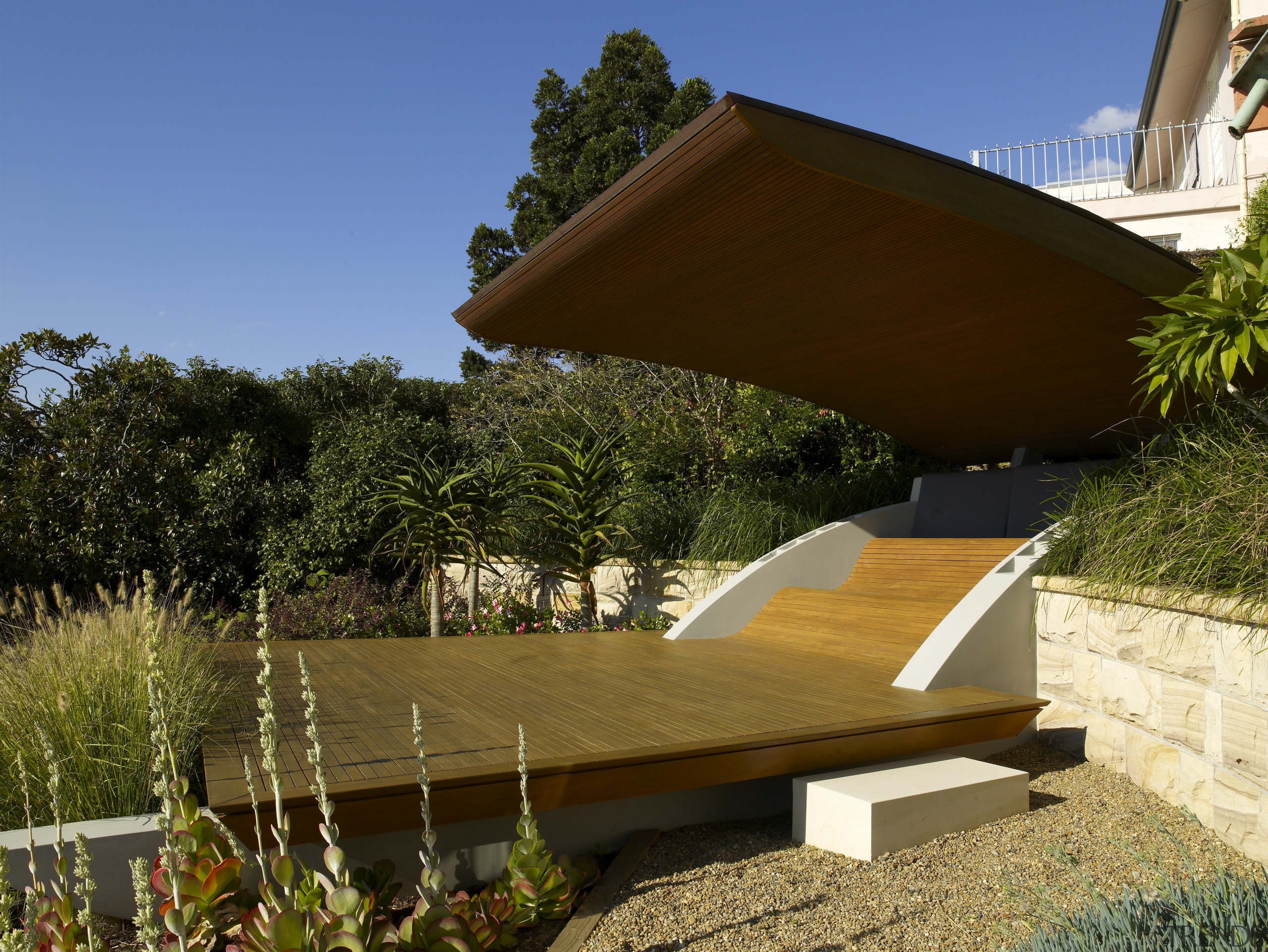 View of a suburban garden which features pavilion architecture, house, outdoor furniture, outdoor structure, property, real estate, villa, brown