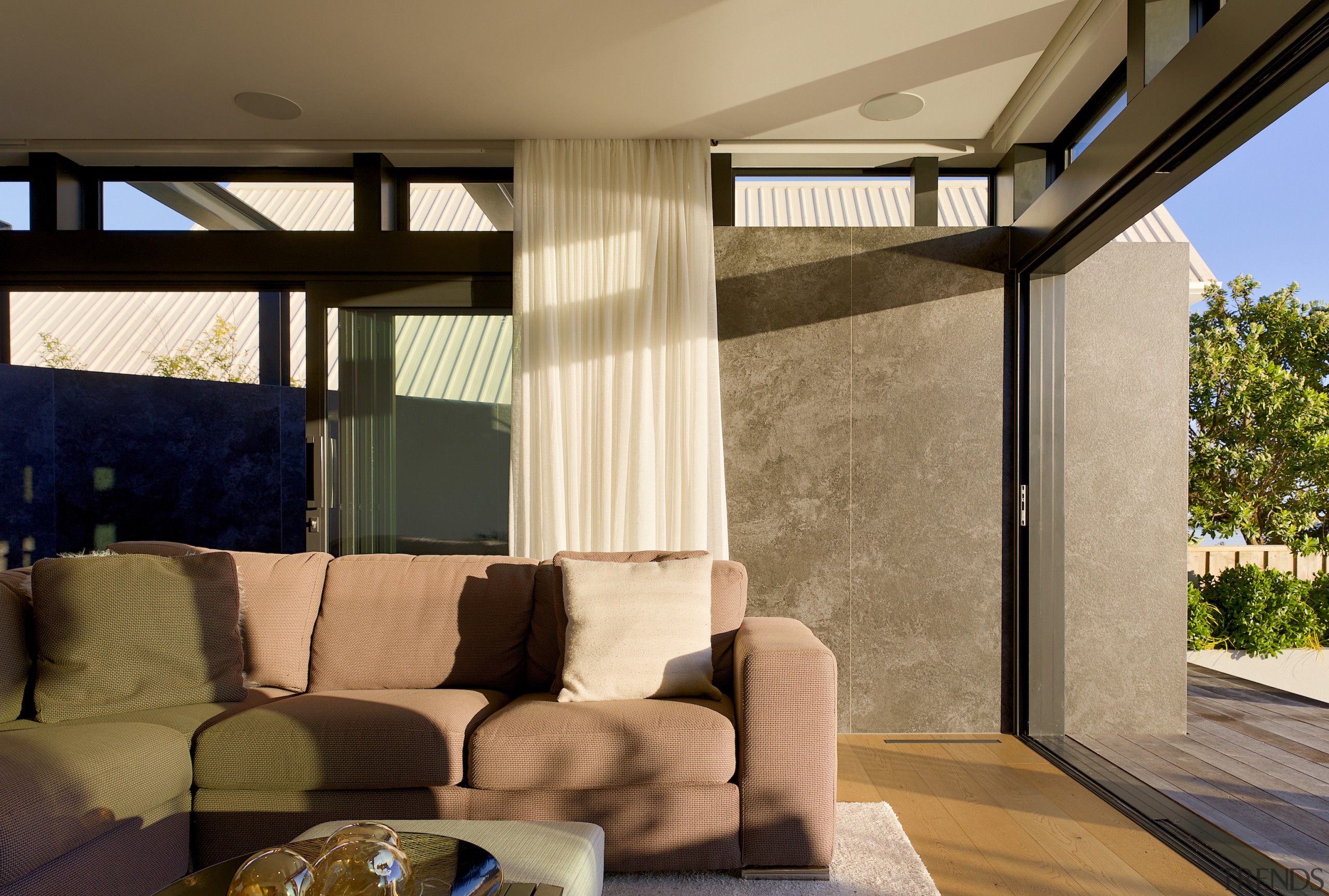 Living room with natural toned tile wall at 