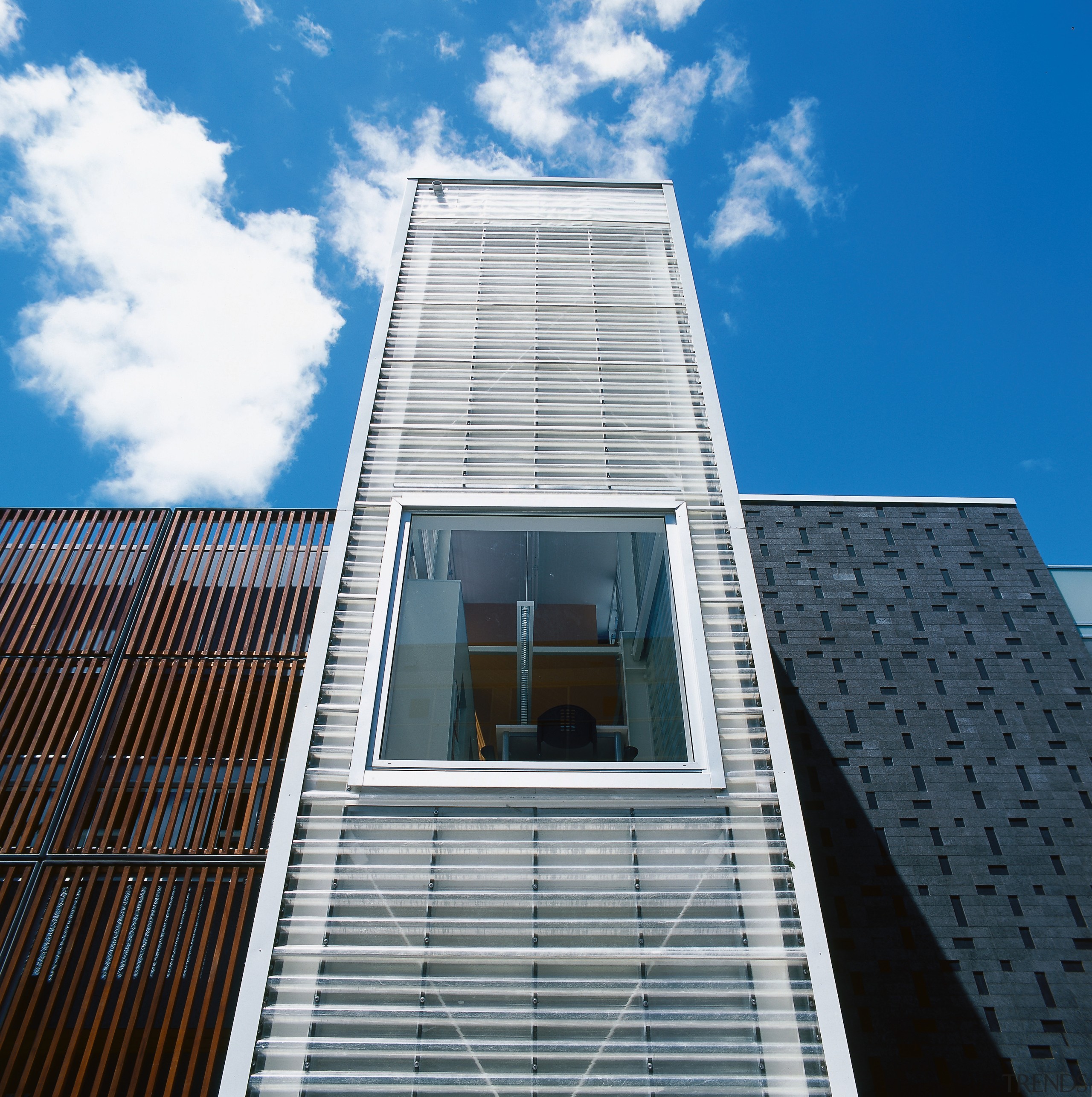 An exterior view of the library. - An architecture, building, cloud, commercial building, condominium, corporate headquarters, daylighting, daytime, elevation, facade, headquarters, landmark, metropolis, metropolitan area, residential area, sky, skyscraper, symmetry, tower, tower block, urban area, window, white