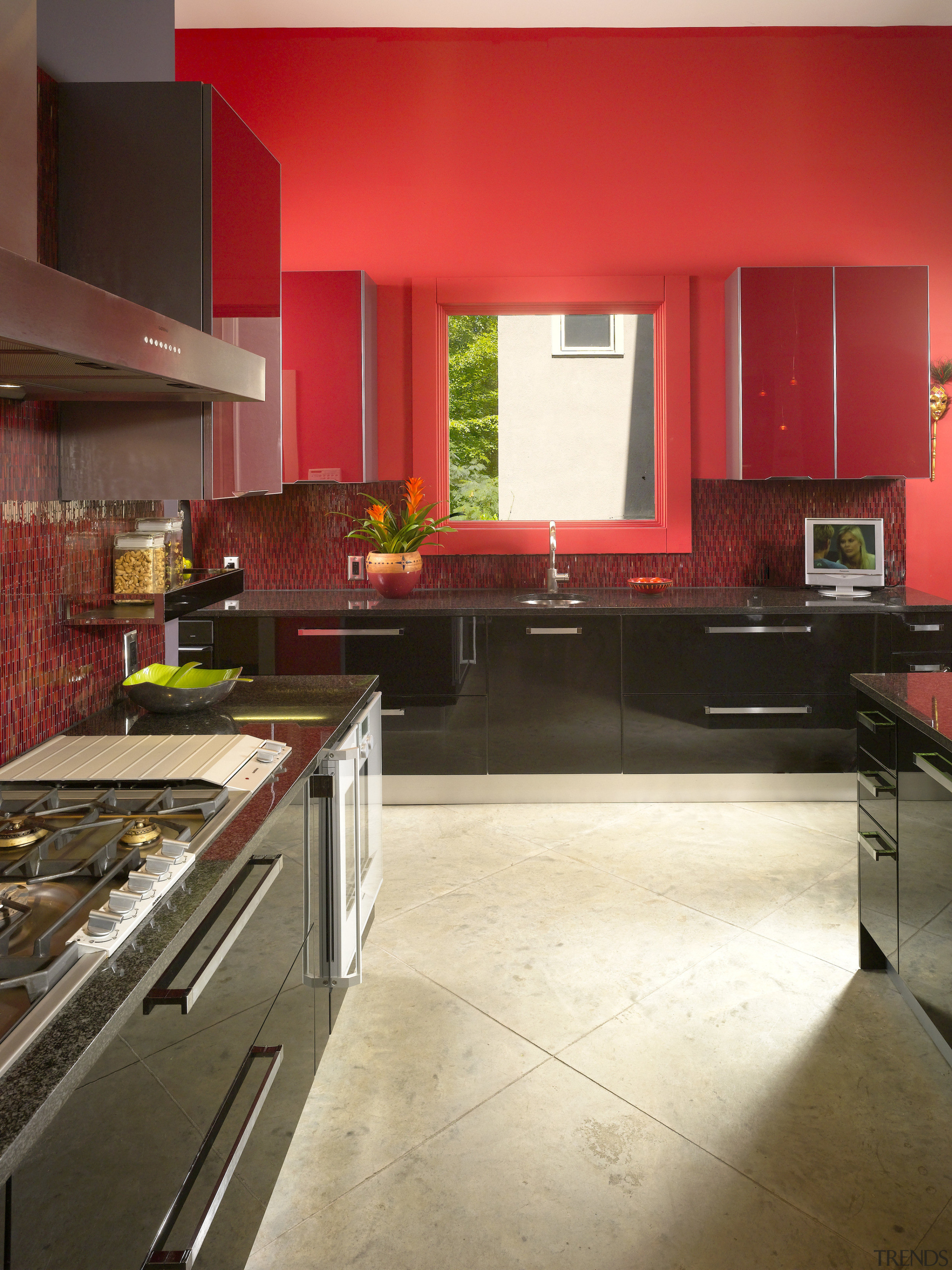 View of kitchen with red feature wall, red cabinetry, countertop, floor, flooring, hardwood, interior design, kitchen, laminate flooring, room, wood flooring, brown, red