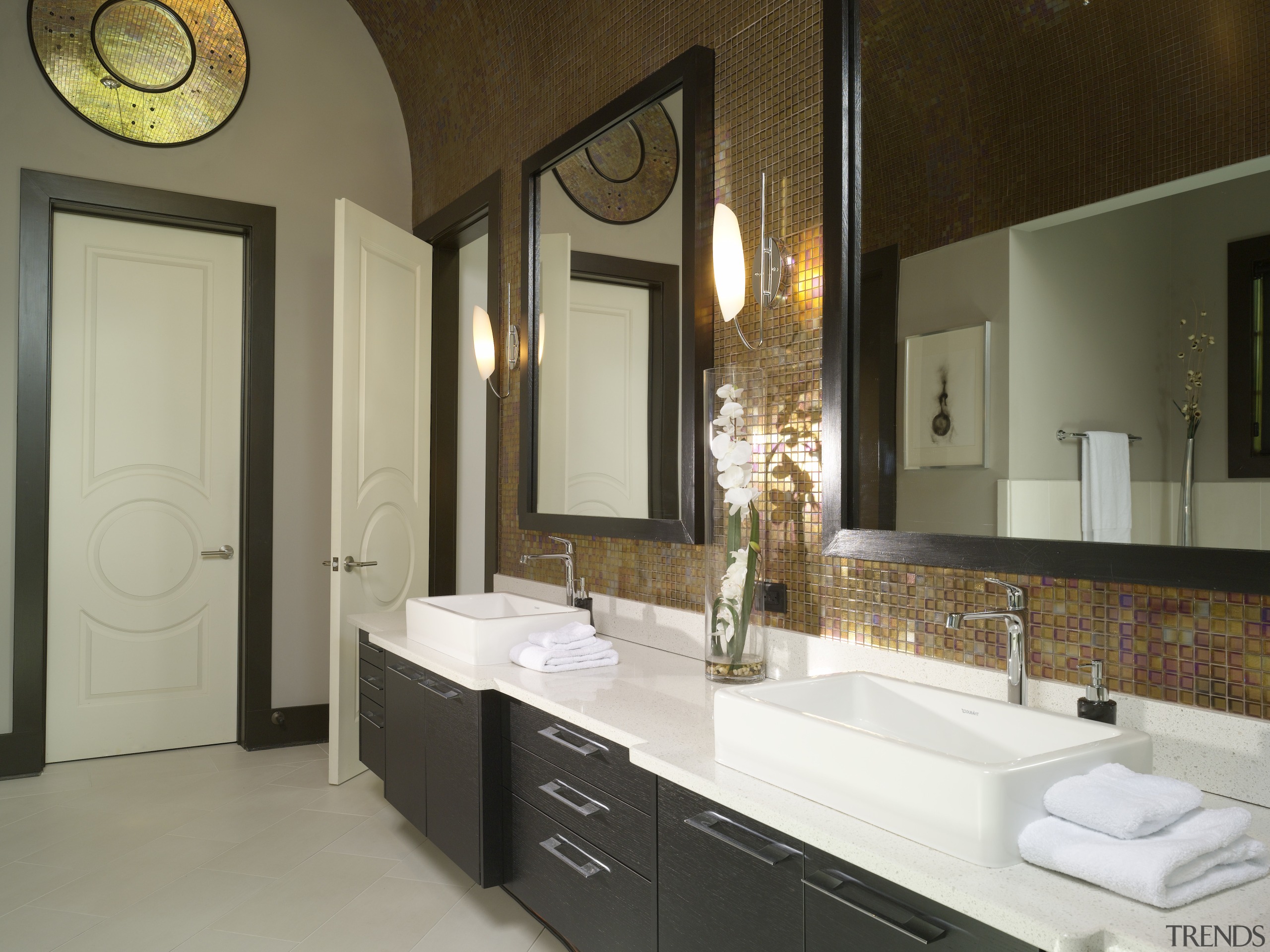 The oversized wall mirrors match the generous scale bathroom, countertop, home, interior design, room, sink, brown, gray