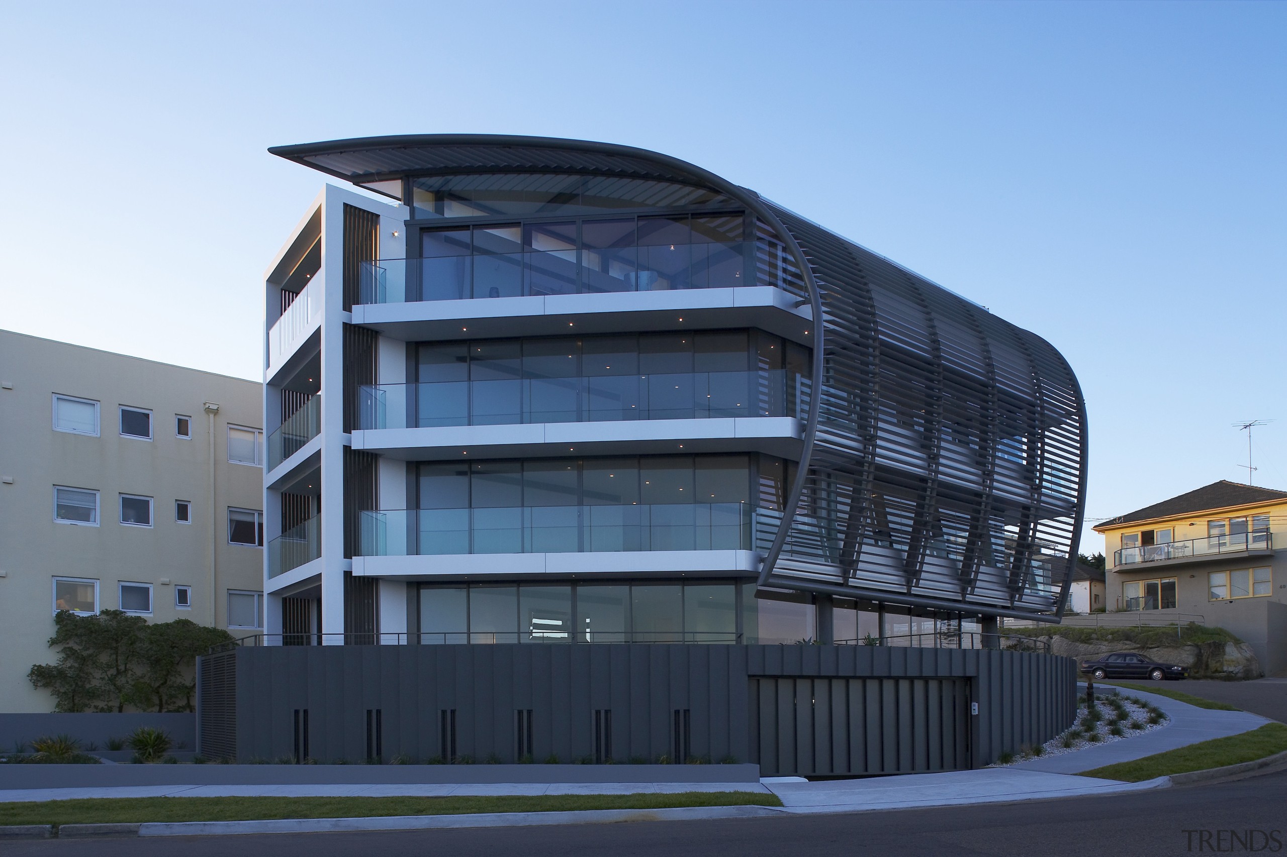 Exterior view of a Sydney apartment building which apartment, architecture, building, commercial building, condominium, corporate headquarters, facade, headquarters, house, metropolitan area, mixed use, residential area, sky, structure, blue, teal