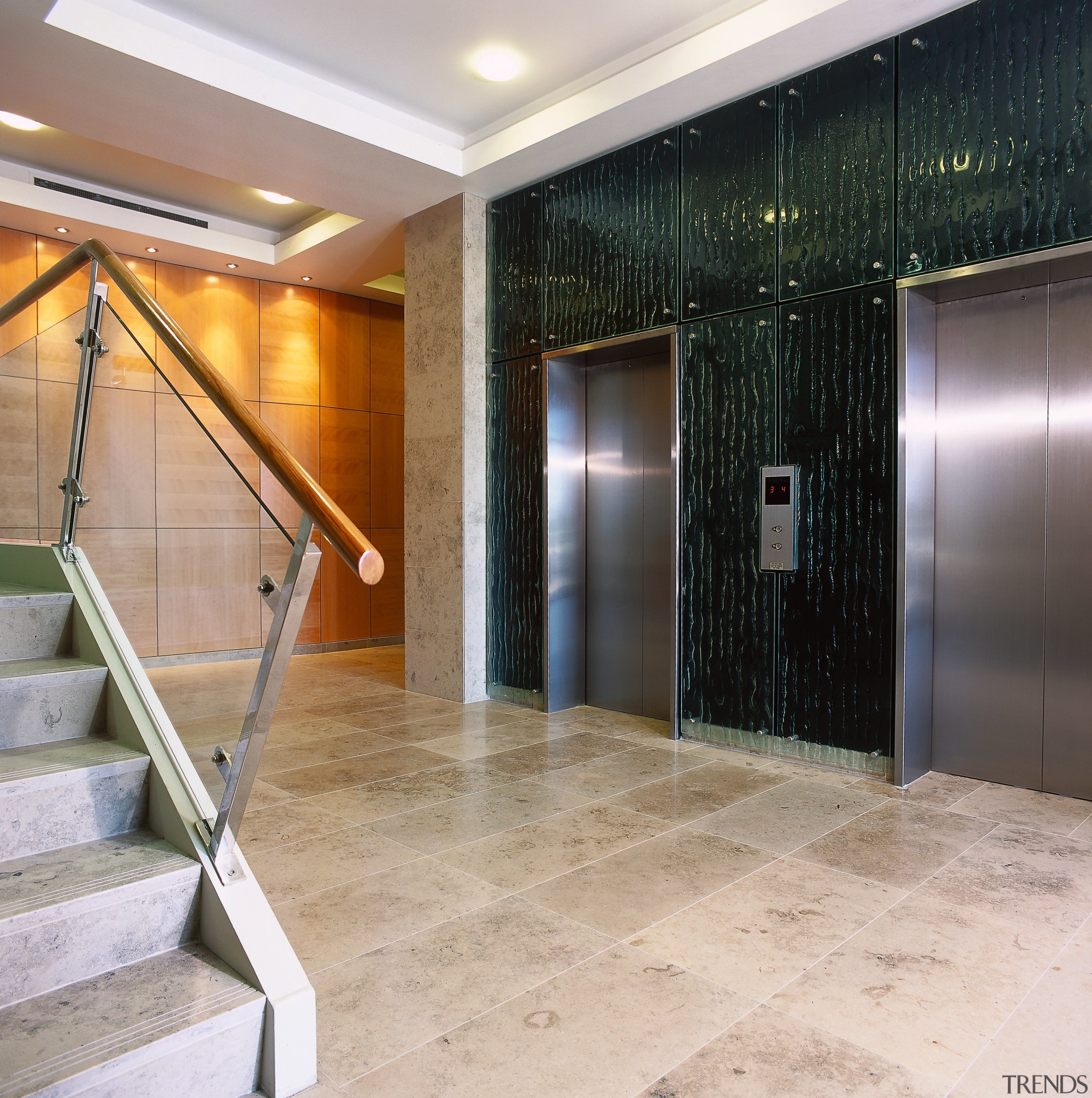 Entrance lobby with stone flooring, lift doors, textured ceiling, floor, flooring, interior design, lobby, real estate, tile, wall, gray
