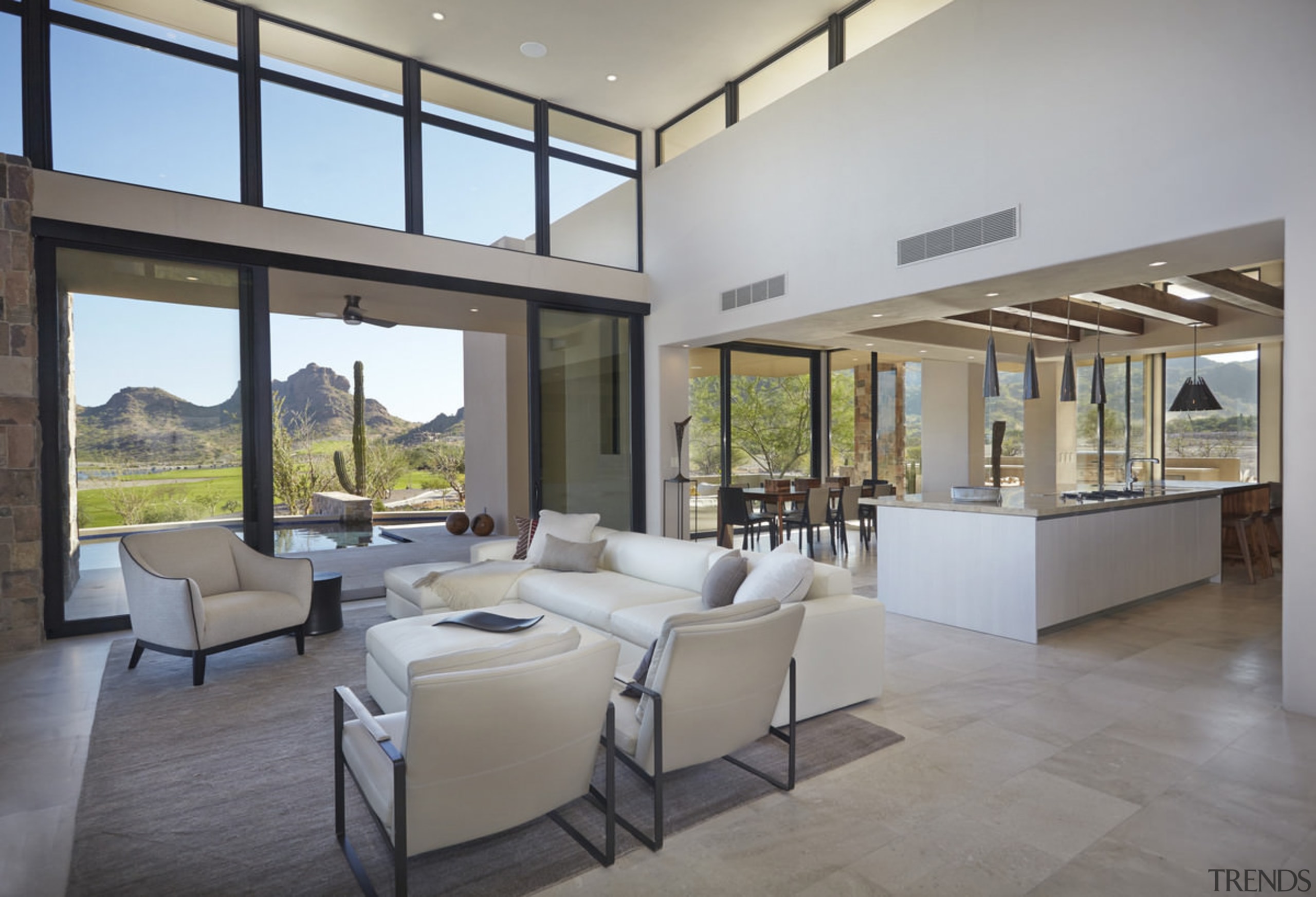 There's an easy flow from the kitchen into ceiling, daylighting, estate, floor, flooring, house, interior design, living room, lobby, property, real estate, window, gray