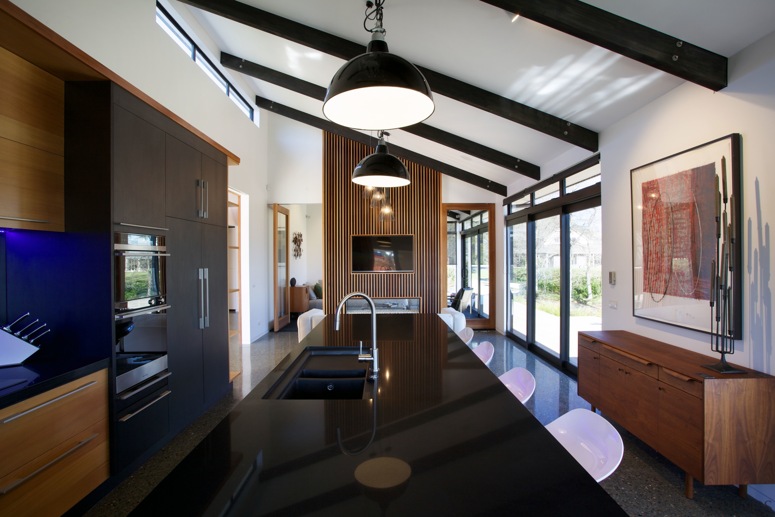 Black cabinets anchor both ends of the kitchen architecture, house, interior design, real estate, black, gray