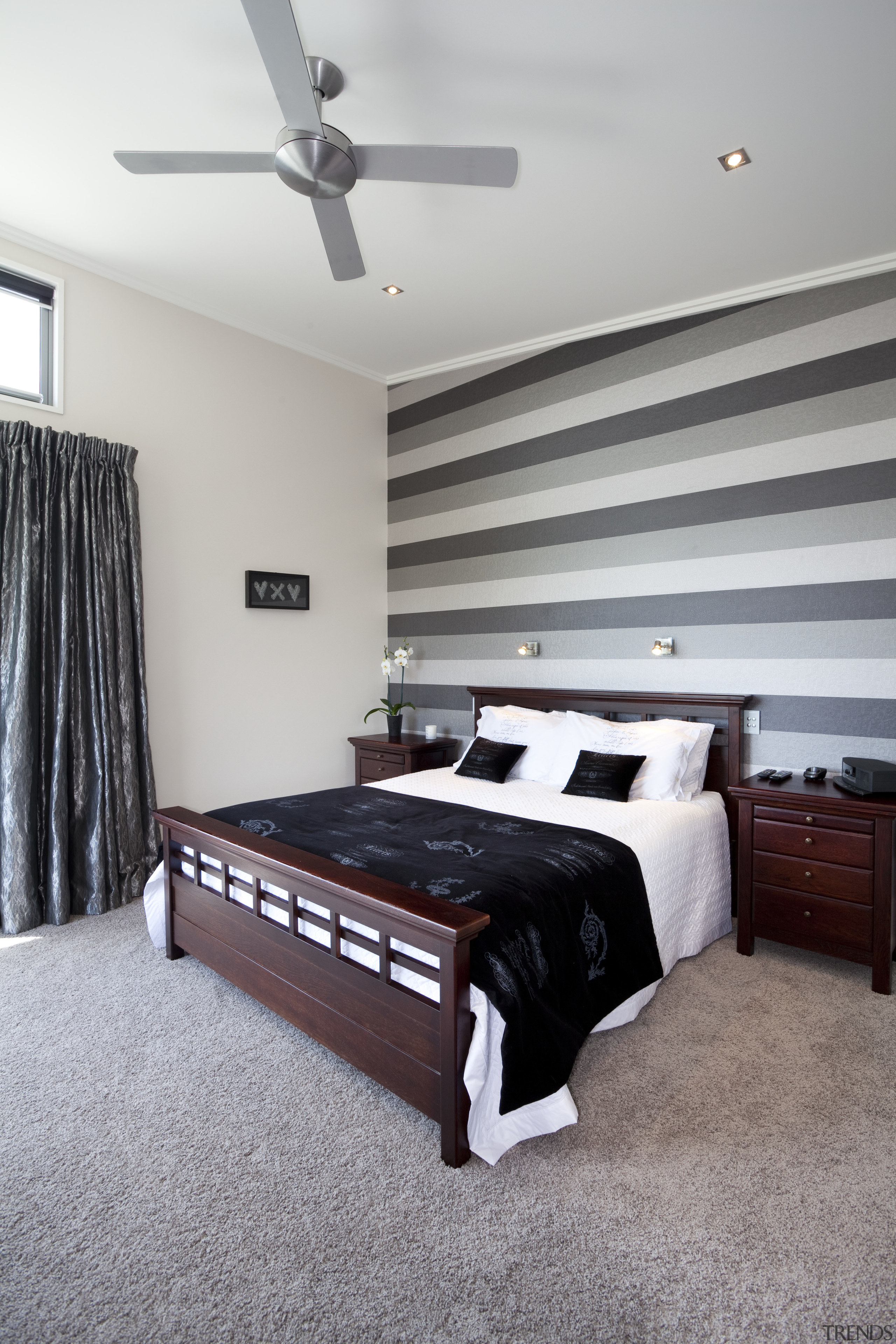 The flooring for this Otago home was chosen bed, bed frame, bedroom, ceiling, floor, flooring, furniture, home, interior design, property, real estate, room, wall, wood, gray