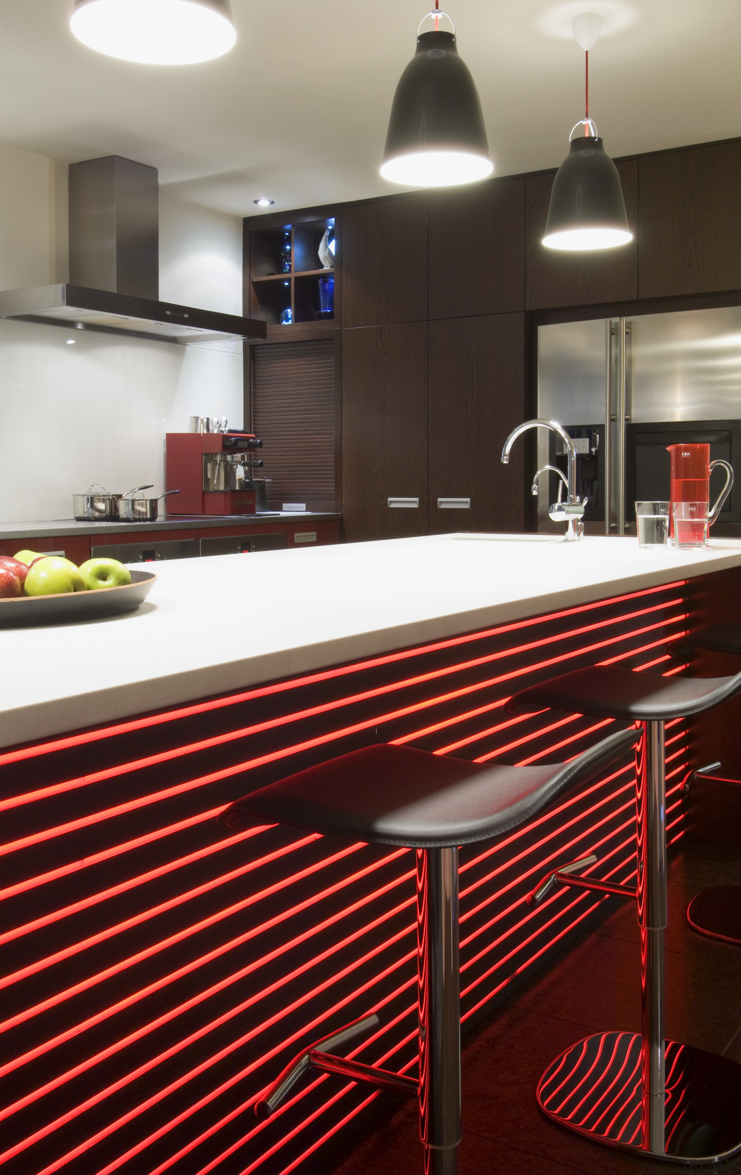 View of open-planned kitchen which features a kitchen countertop, floor, flooring, interior design, table, red