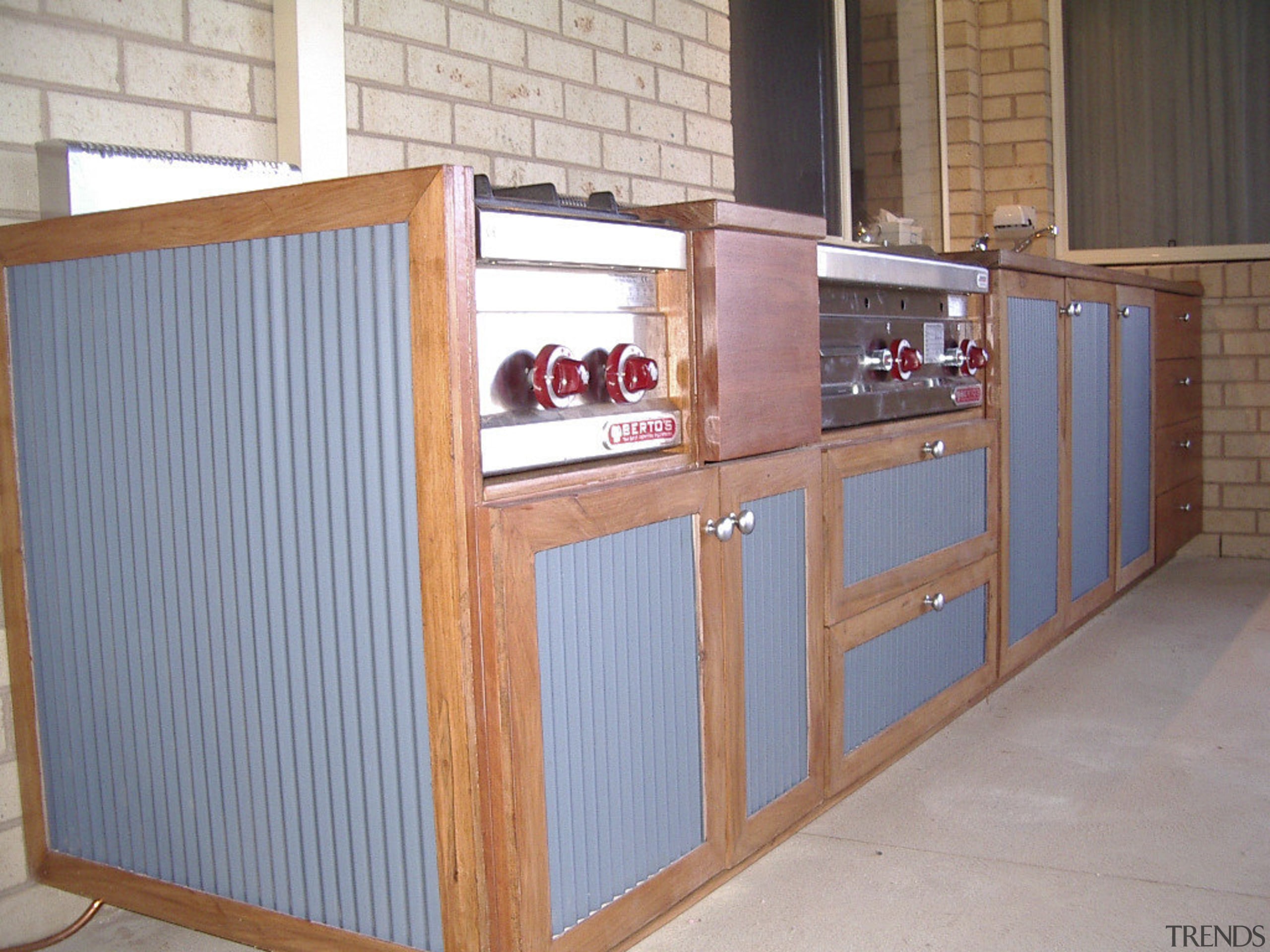 View of an outdoor area which features outdoor furniture, product, wood, gray