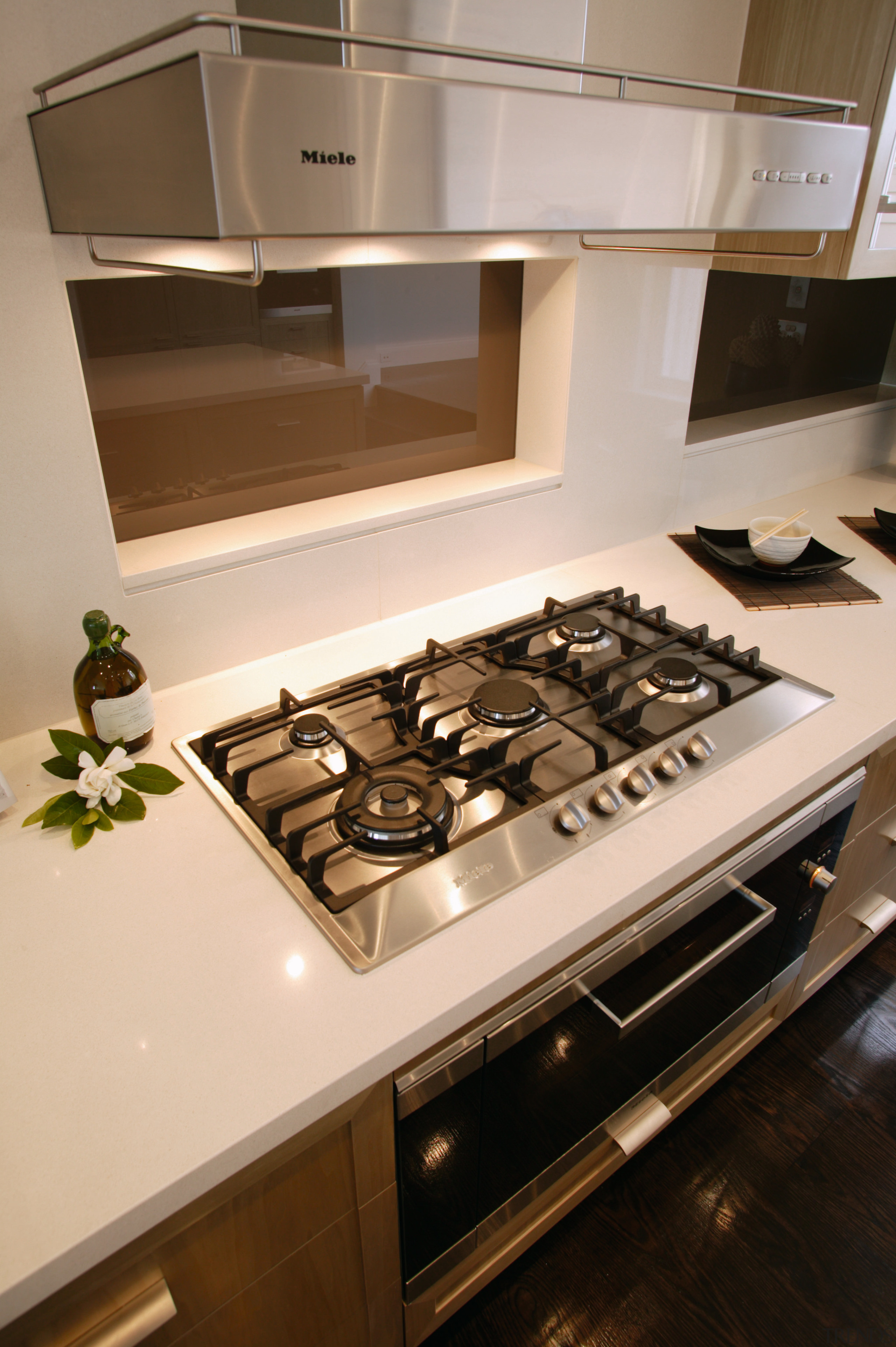 Kitchen with light coloured benchtop, gas cooktop and countertop, furniture, home appliance, interior design, kitchen, kitchen appliance, kitchen stove, orange, brown