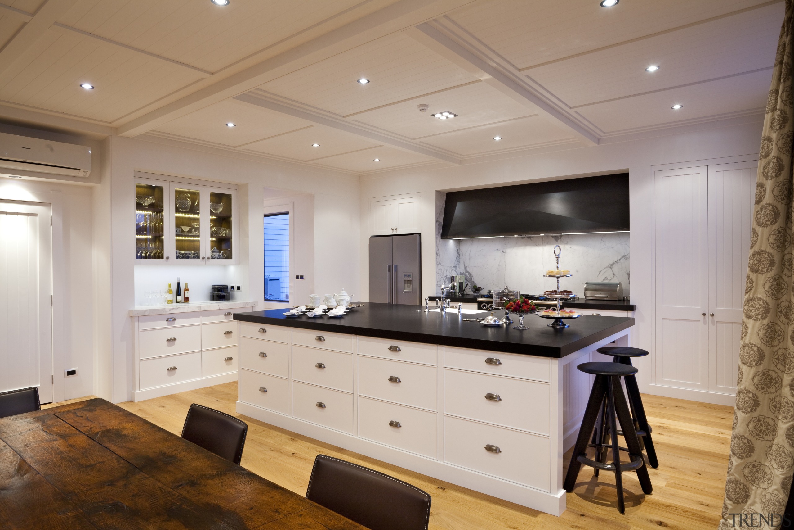 View of kitchen with wooden flooring, white cabinetry cabinetry, ceiling, countertop, cuisine classique, flooring, interior design, kitchen, real estate, room, wood flooring, gray
