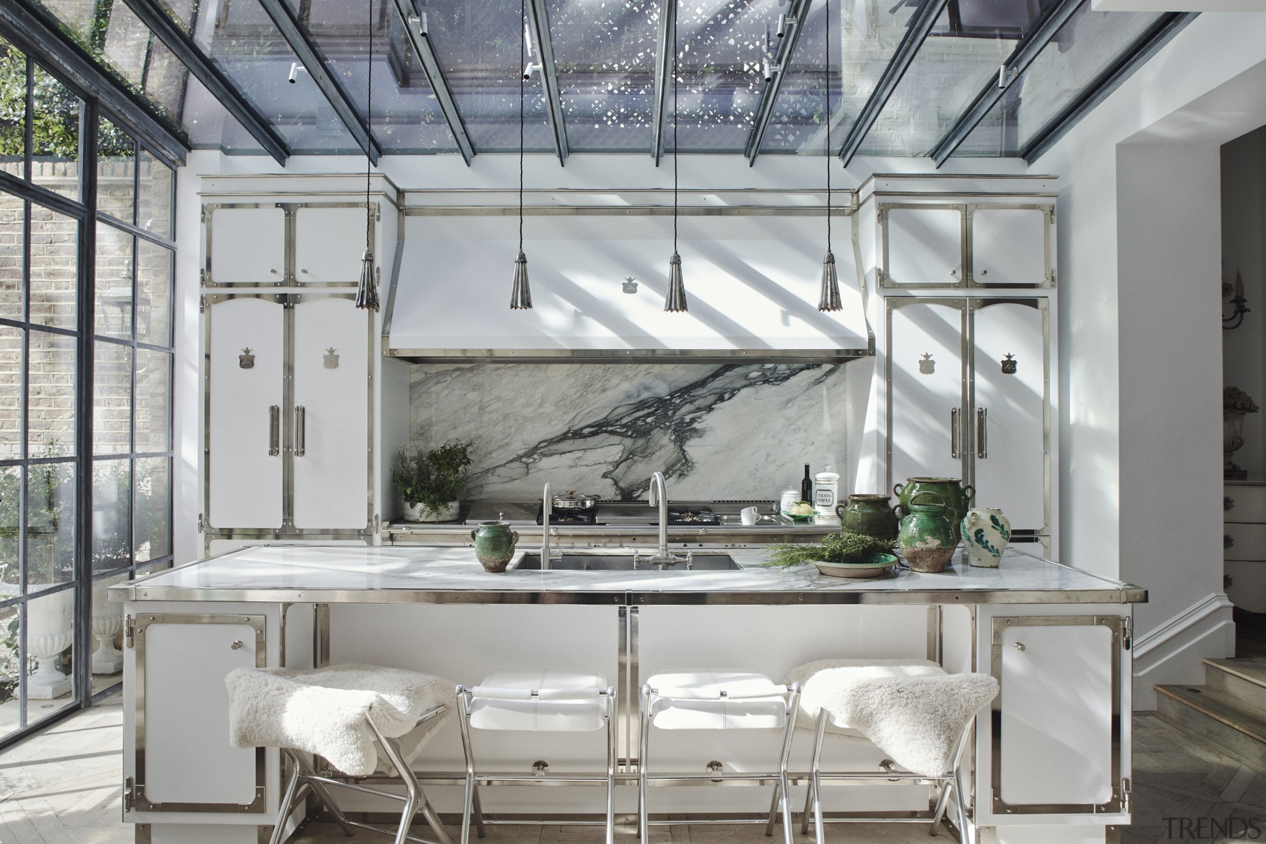 Matte white cabinetry, nickel detailing, antique wooden Versailles 