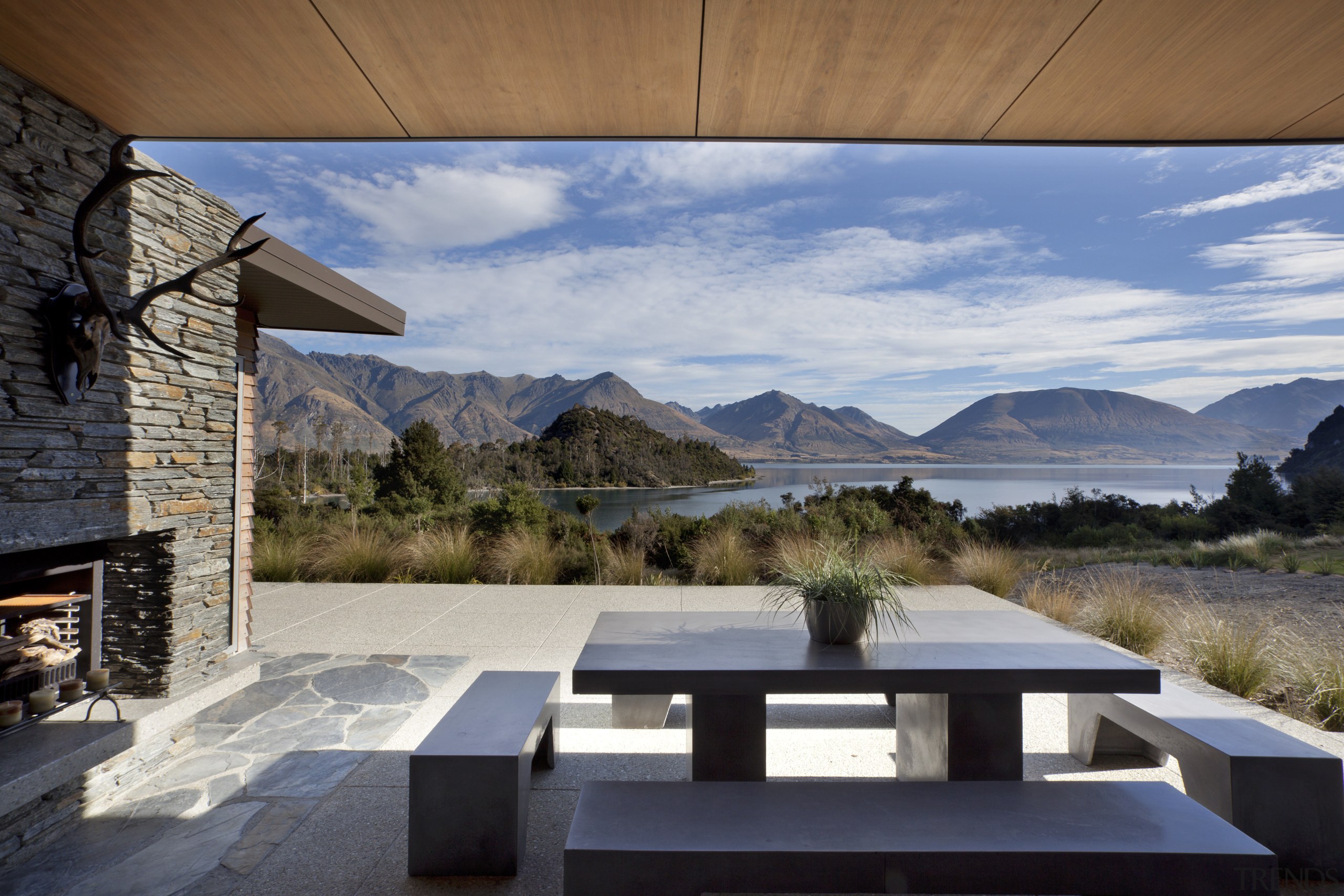 In this lakeside house, wood veneer ceilings run architecture, estate, home, house, interior design, landscape, property, real estate, sky, gray