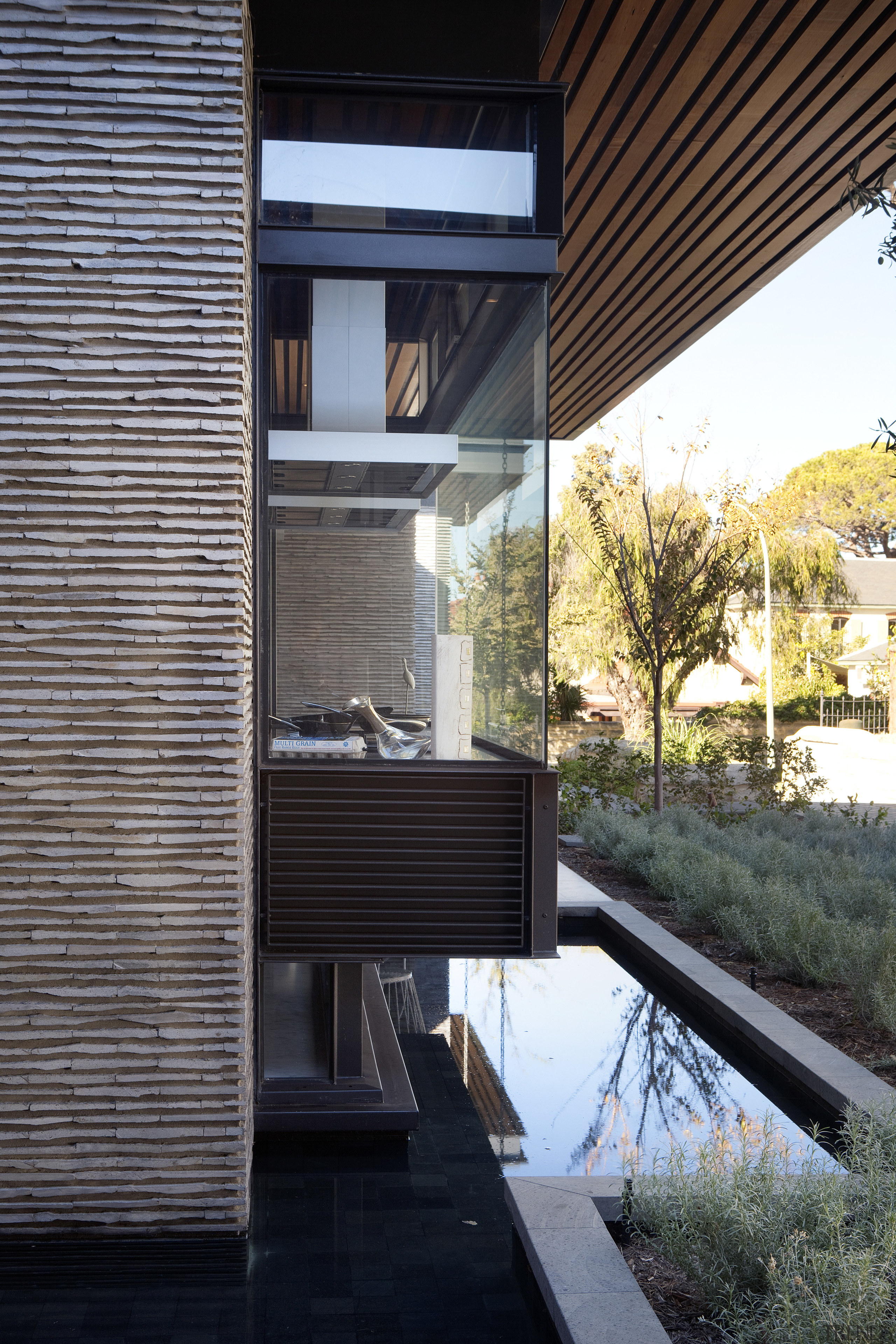 The kitchen in this modern resort-style house is apartment, architecture, building, daylighting, facade, home, house, real estate, residential area, siding, window, black, gray