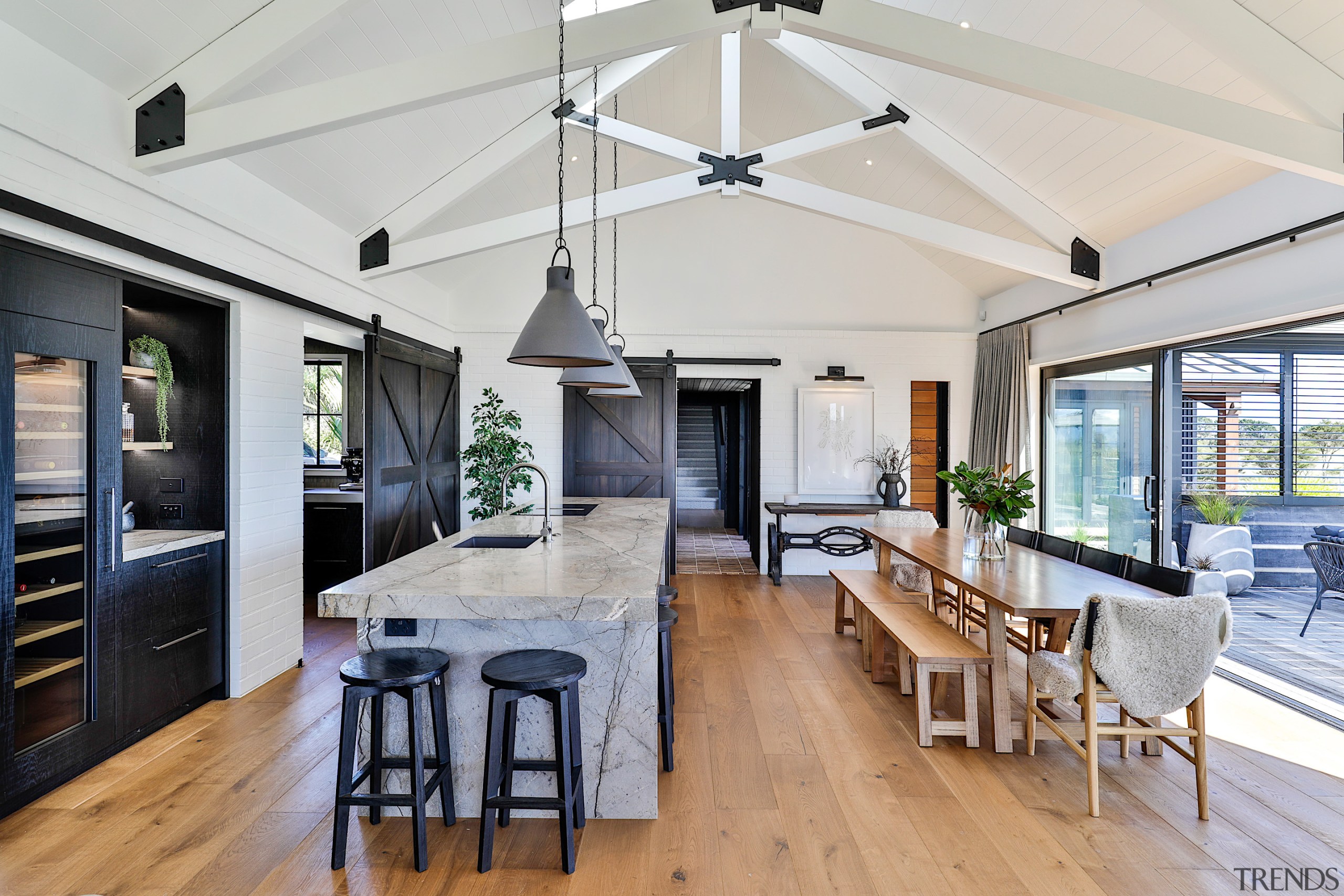 The gabled ceiling with exposed beams connects with 