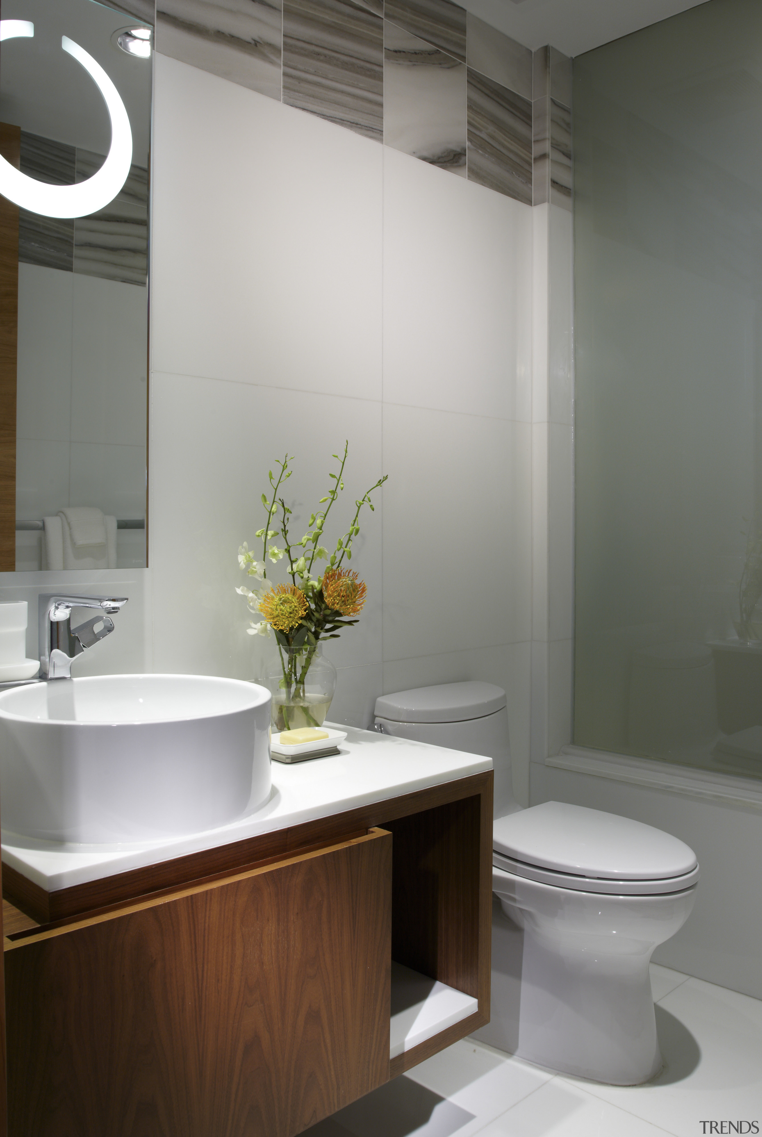 Seen here is a condominium which has been bathroom, bathroom accessory, bathroom cabinet, bidet, ceramic, floor, interior design, plumbing fixture, product design, room, sink, tap, gray