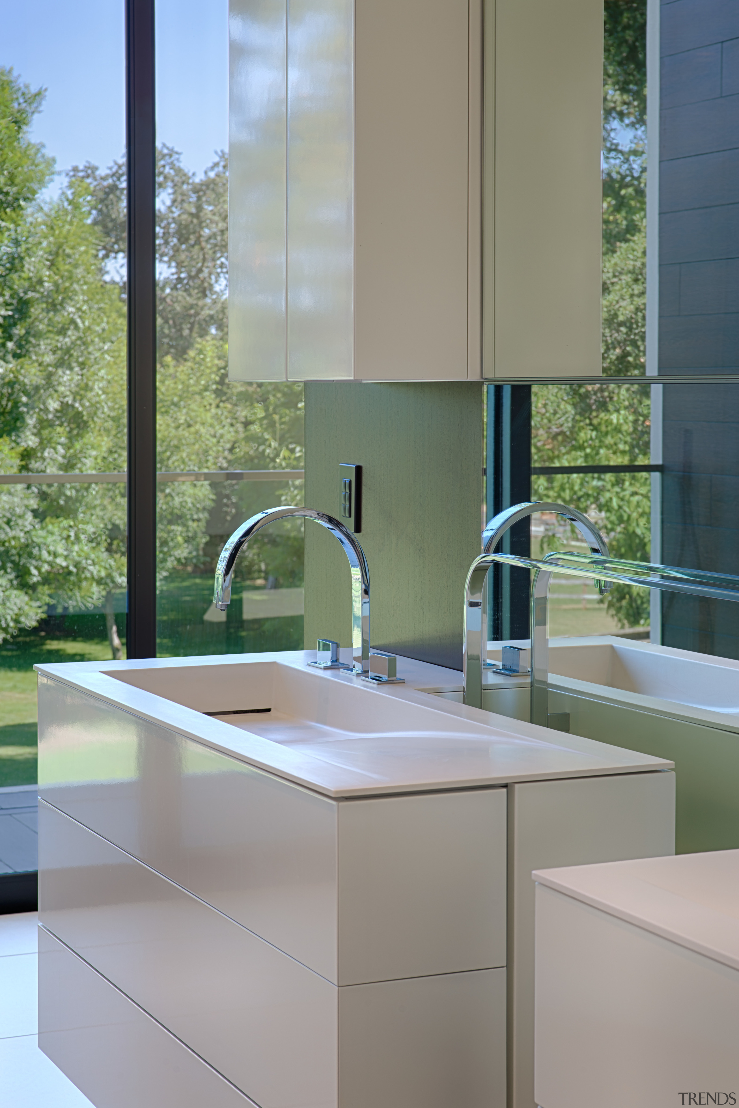 Wading basins are integrated into the vanities on bathroom, bathroom accessory, bathroom cabinet, countertop, interior design, kitchen, sink, gray