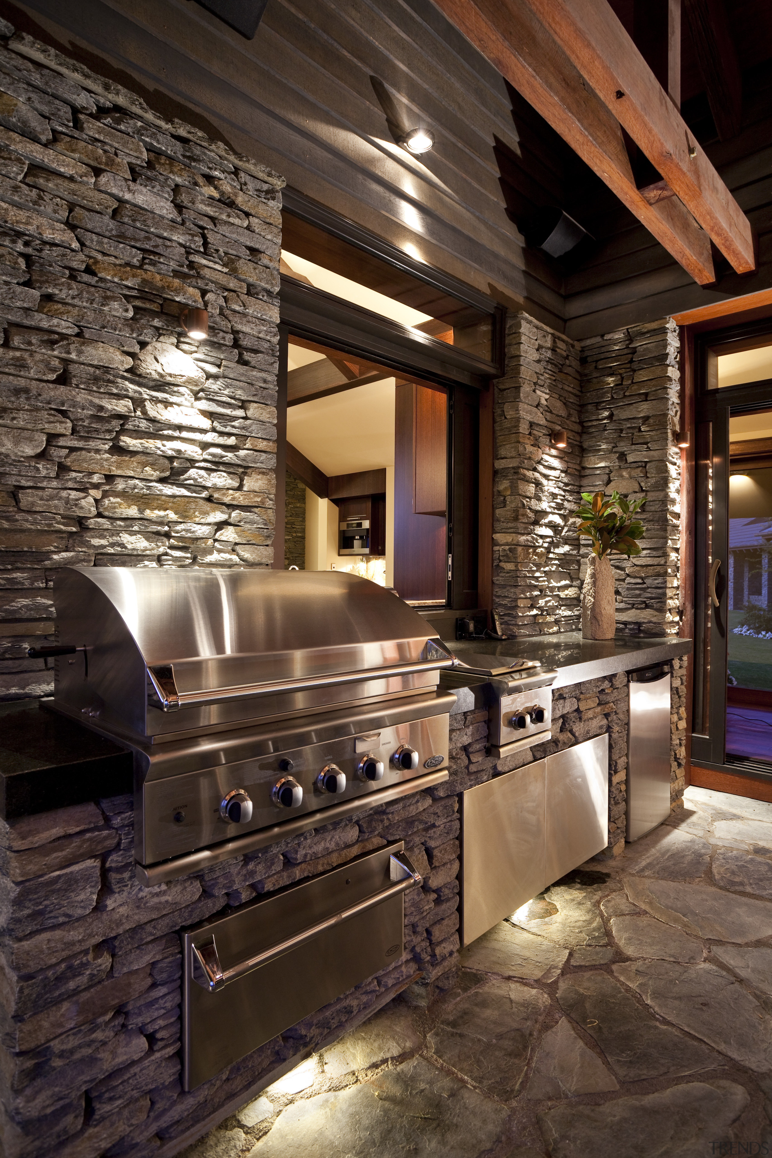 This country house features a covered lanai designed ceiling, countertop, flooring, home, interior design, kitchen, lighting, room, brown